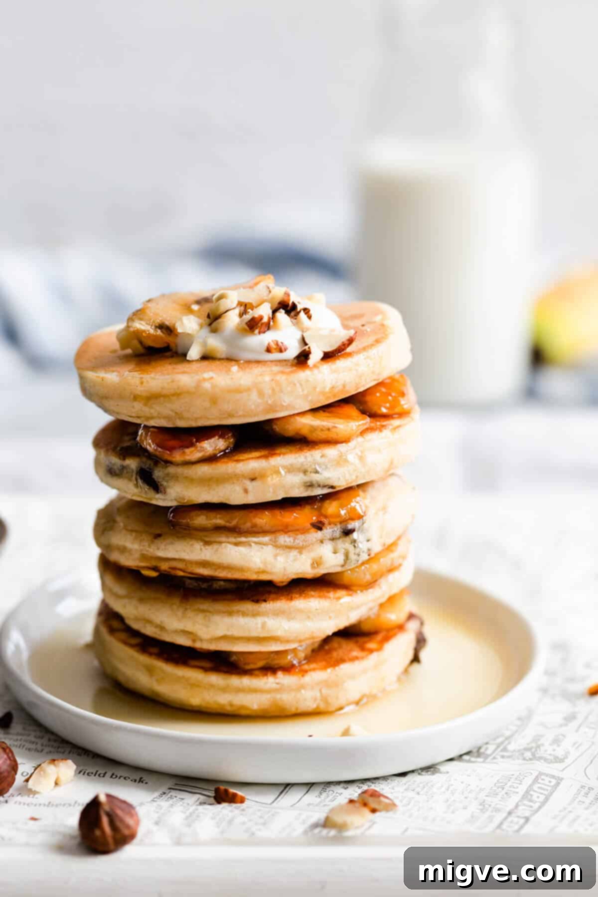 Caramelized Banana Hazelnut Stack 4 Close-up side view of a stack of pancakes with thick layers of golden caramelised bananas between them