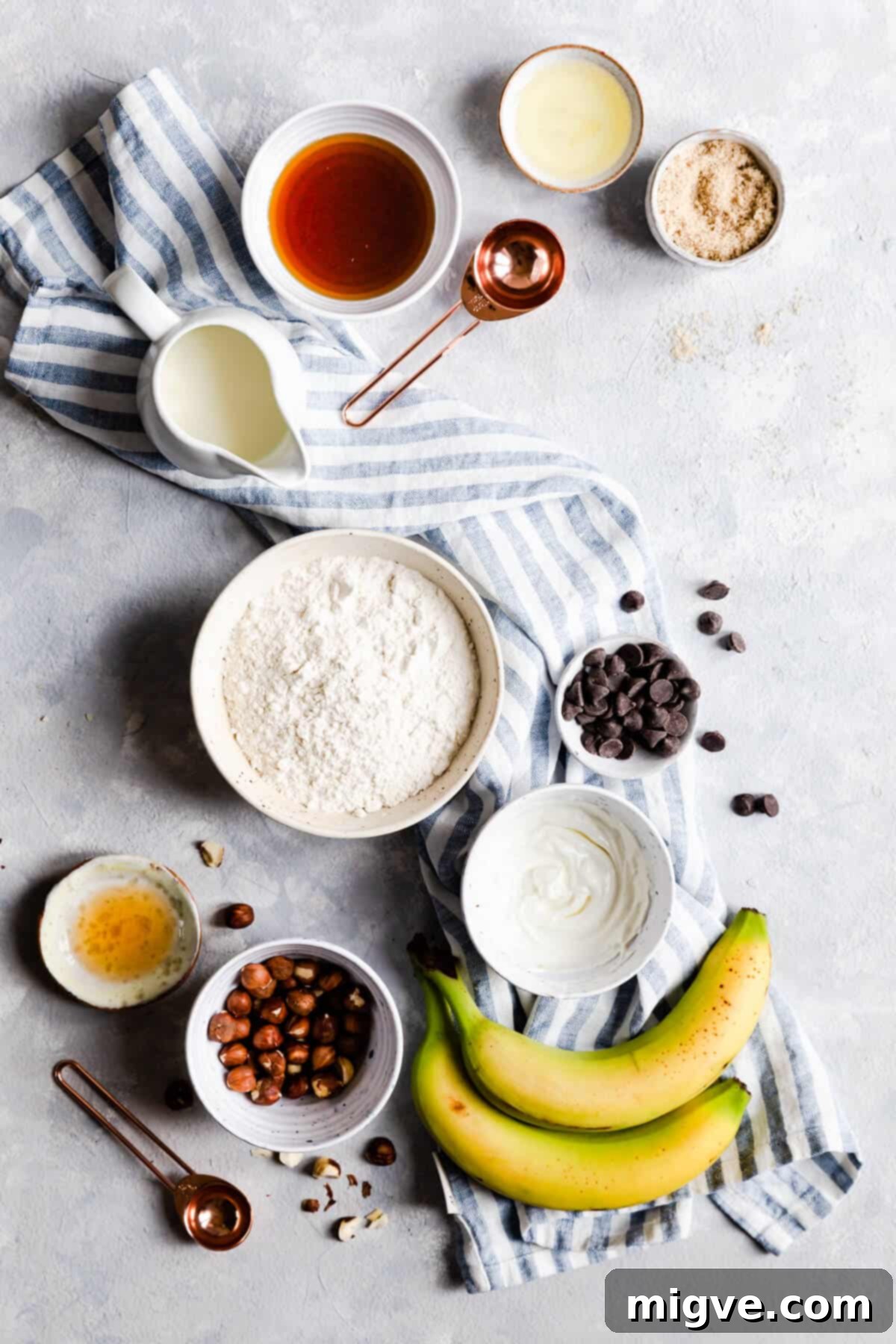 Caramelized Banana Hazelnut Stack 5 Overhead view of bowls containing various ingredients for hazelnut pancakes, neatly arranged