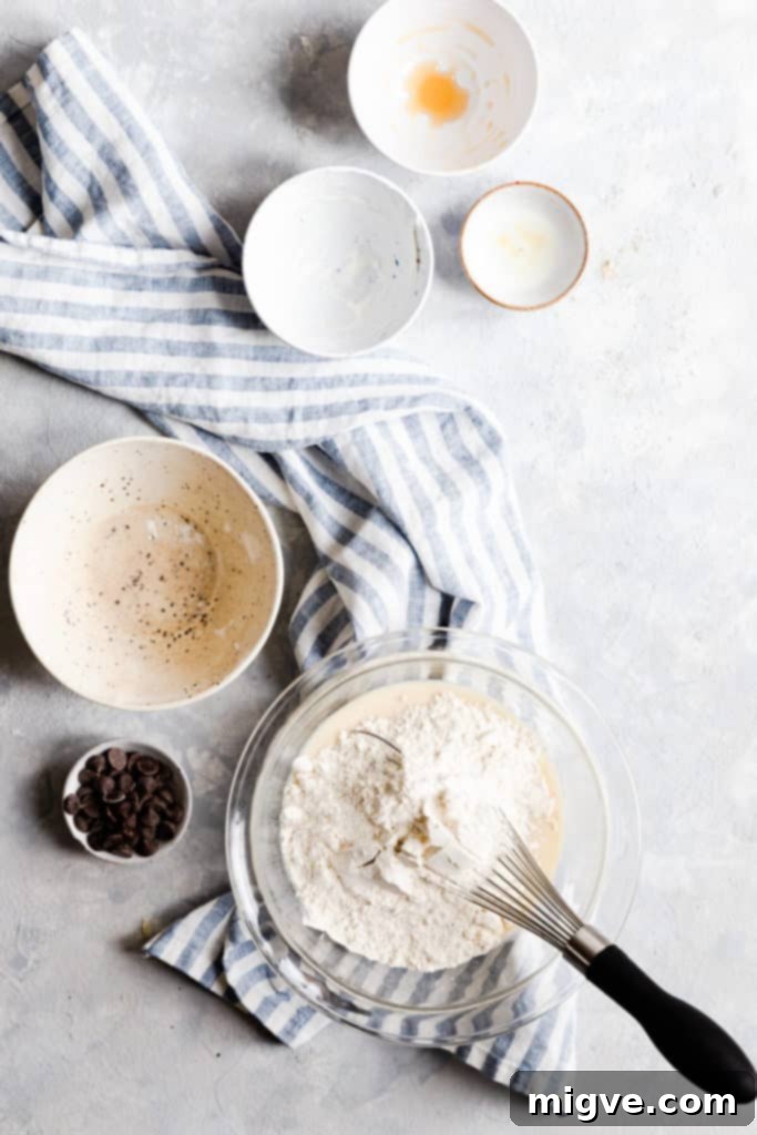 Caramelized Banana Hazelnut Stack 7 Top view of a bowl with pancake batter being prepared, showing the creamy texture