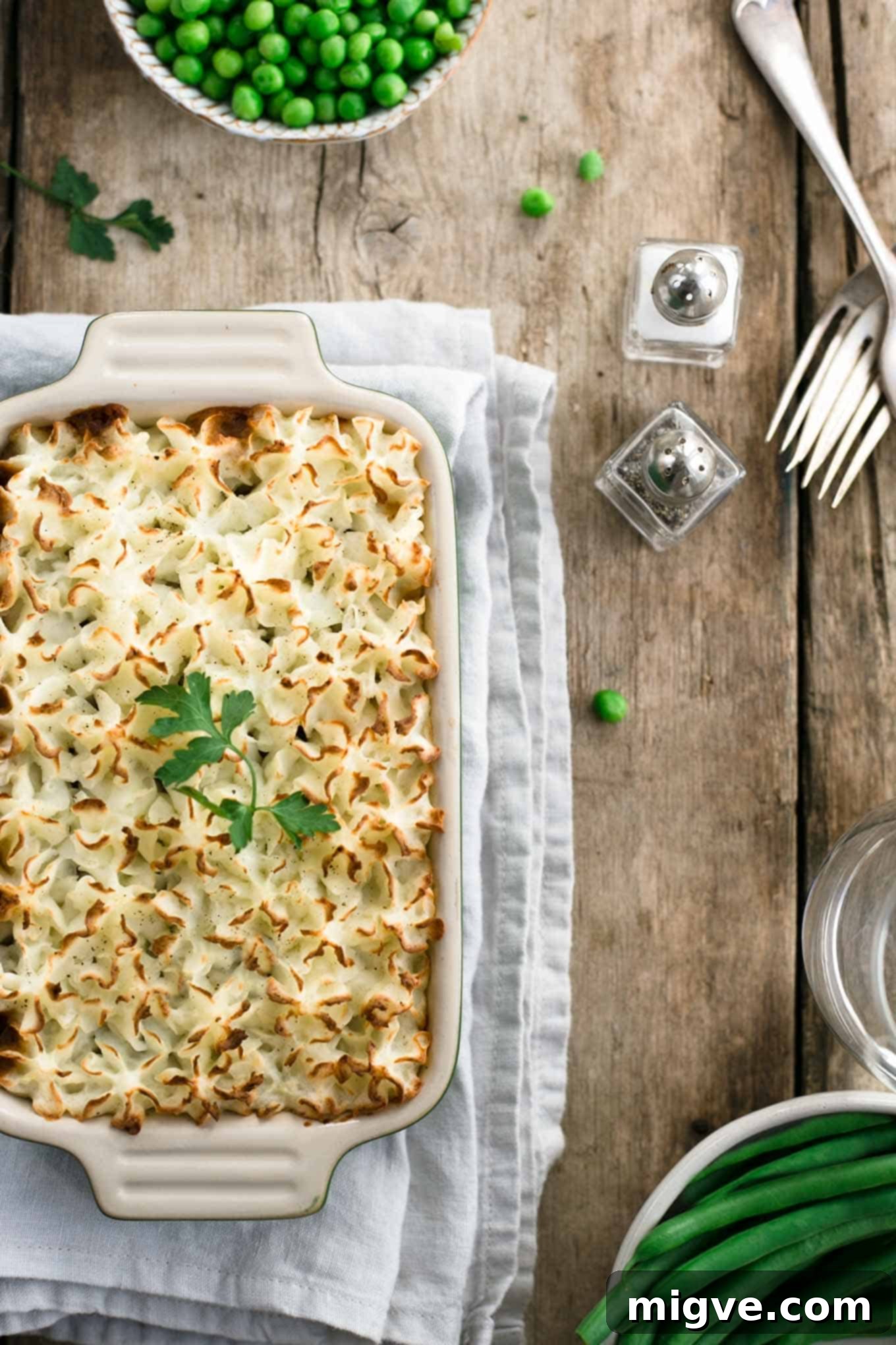 A beautifully presented mini lentil shepherd's pie, golden-brown mashed potato topping, ready to be served. Ideal vegan comfort food for any occasion.