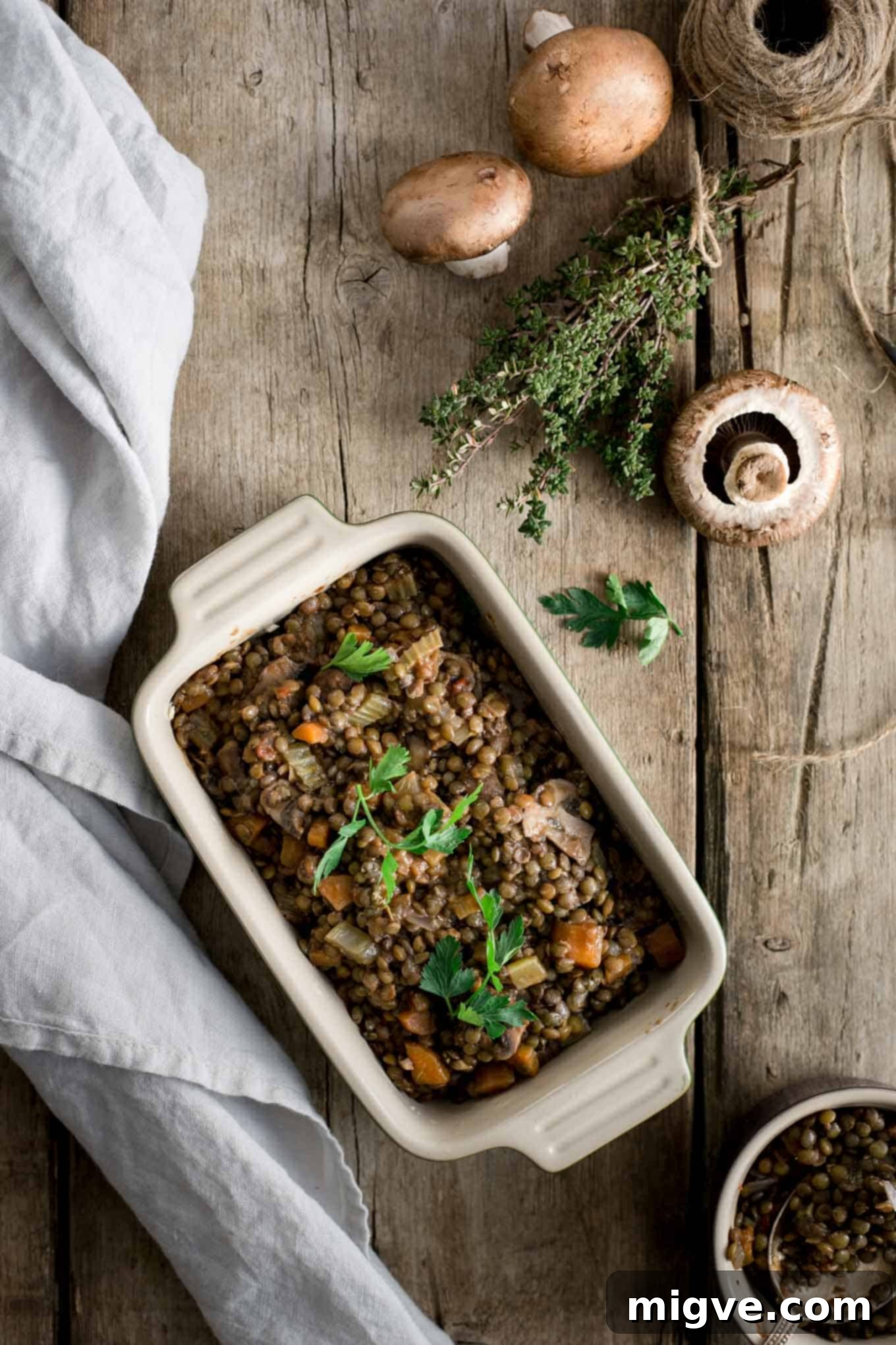 Several mini lentil shepherd's pies cooling on a wire rack, showcasing their perfectly baked golden tops and rustic appeal.