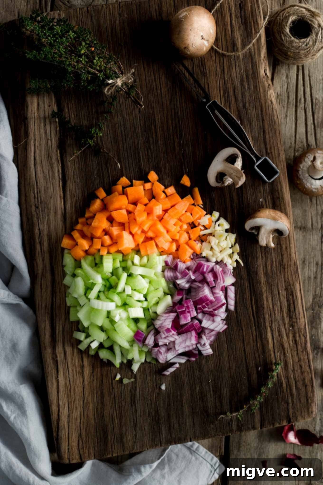 A trio of mini lentil shepherd's pies served on a wooden board, garnished with fresh herbs, emphasizing their hearty and appealing nature.