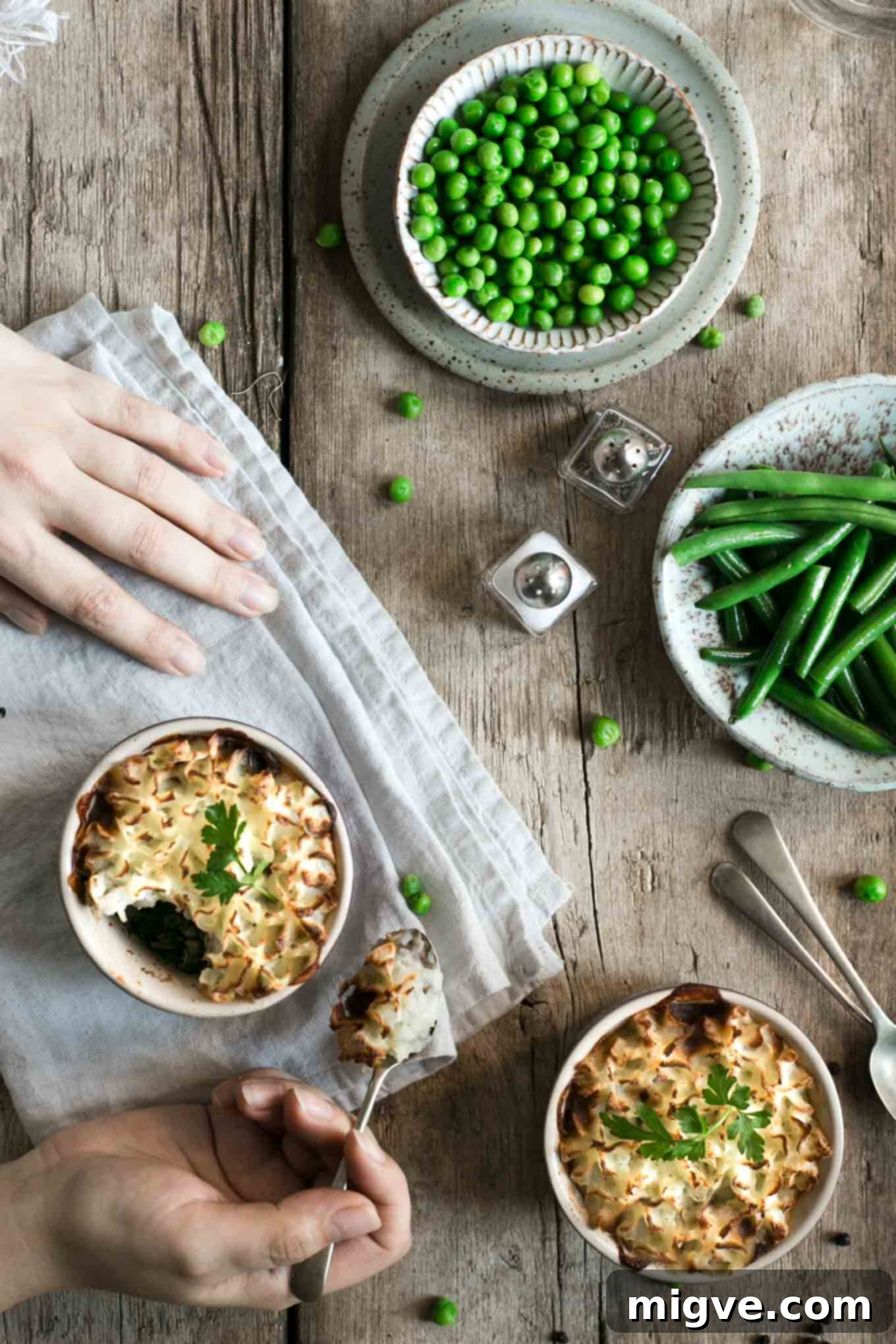 Several mini lentil shepherd's pies presented in rustic individual pie dishes, highlighting their perfect portion size and comforting appeal.