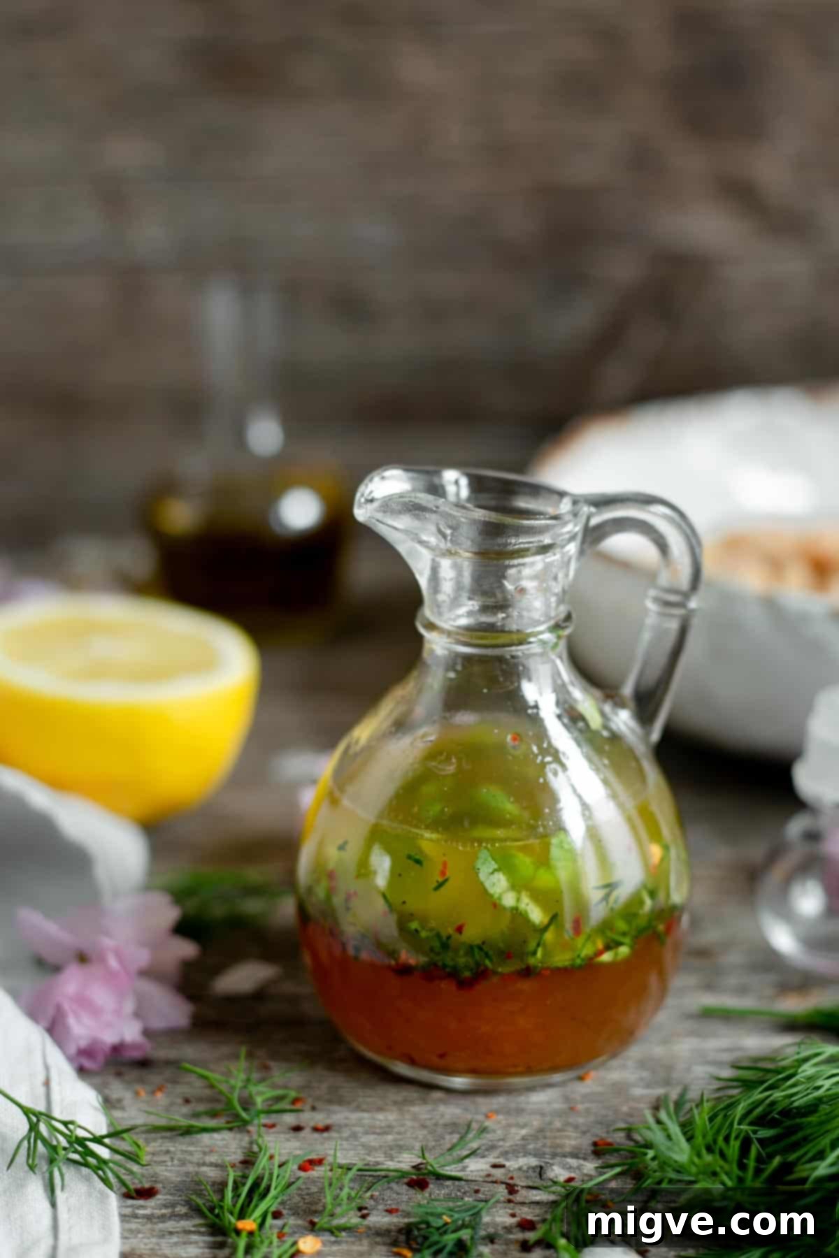 Tomato and quinoa salad jars with homemade vinaigrette for a healthy, vegan meal prep idea.