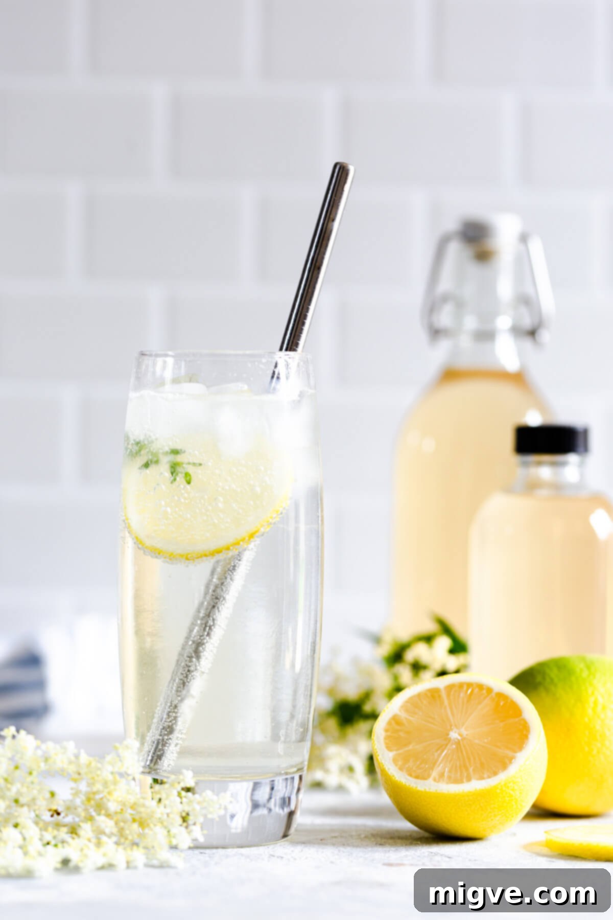 side close up at a tall glass with elderflower cordial and sparkling water