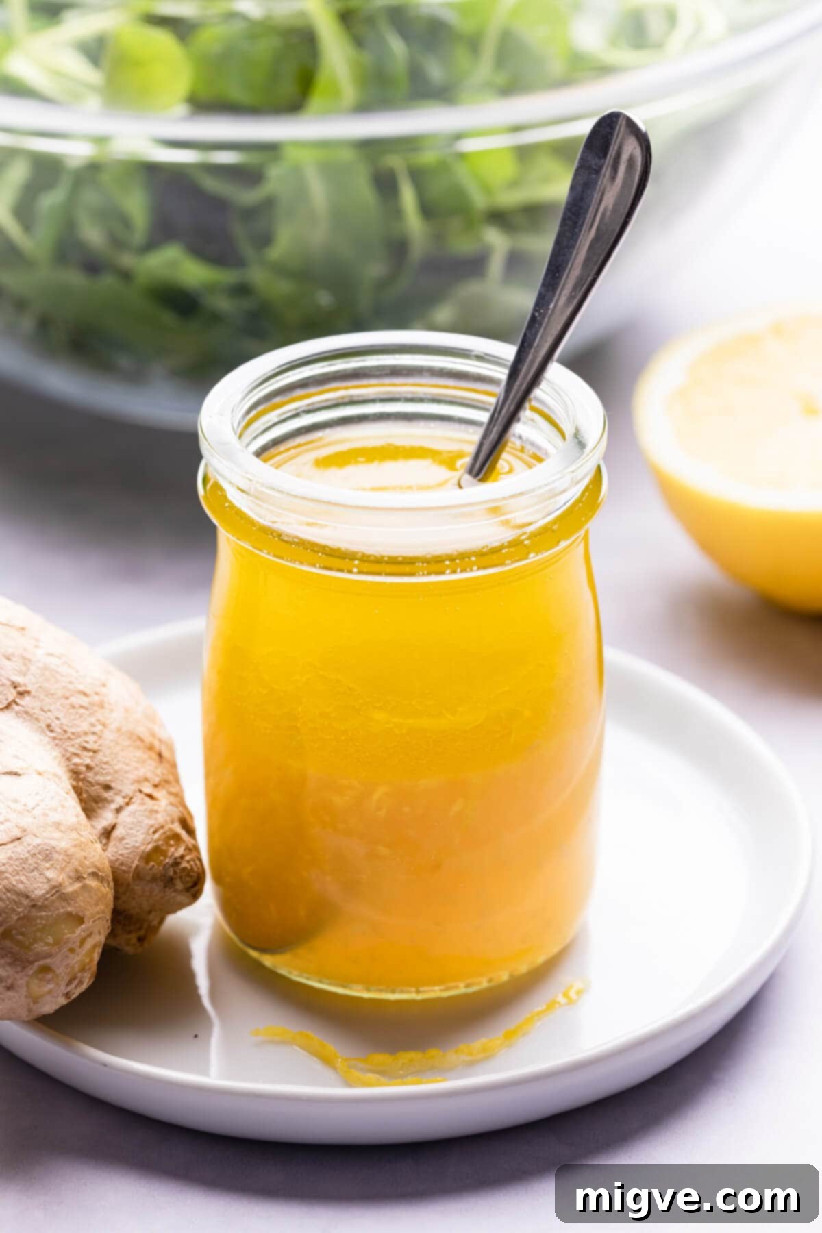 side close up at a ginger vinaigrette in a glass jar