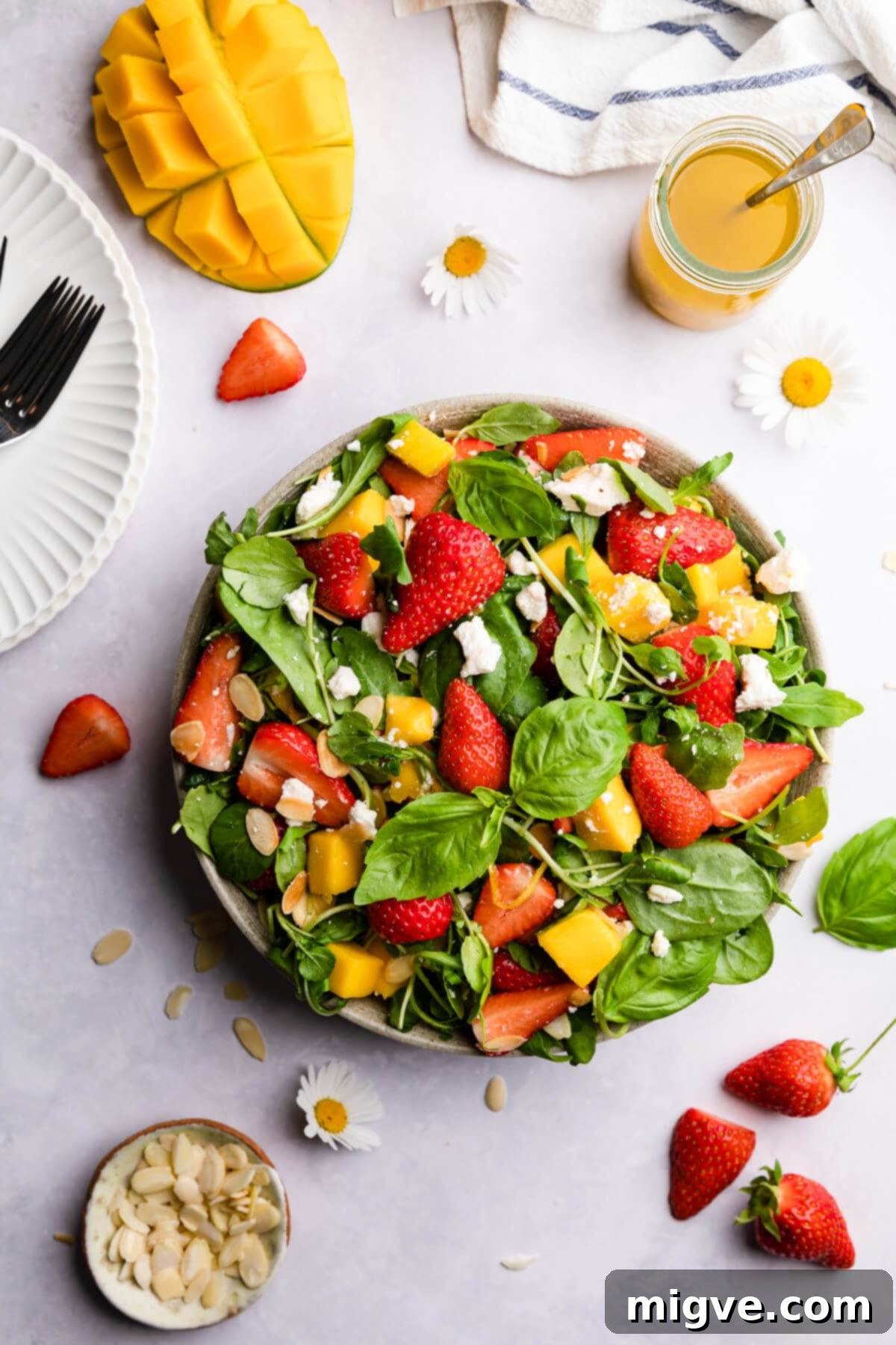 overhead view of strawberry mango salad topped with feta cheese