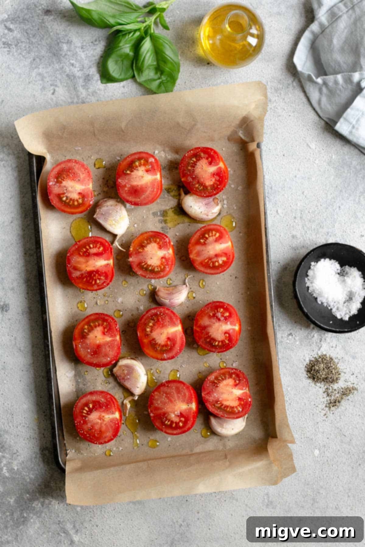 Close-up of sweet and juicy red tomatoes, halved and ready for oven roasting, perfect for bucatini pasta