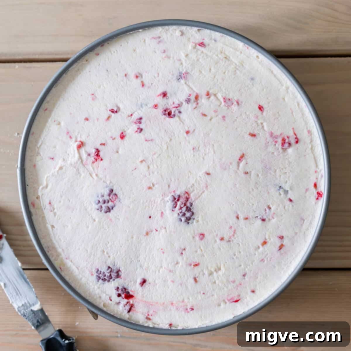 round baking tin raspberry white chocolate cheesecake filling inside.