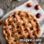 Plum and almond pie with decorative lattice pattern