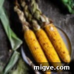Overhead shot of oven-roasted corn on the cob with chilli butter