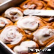 Fresh pumpkin rolls with cinnamon, topped with cream cheese icing.