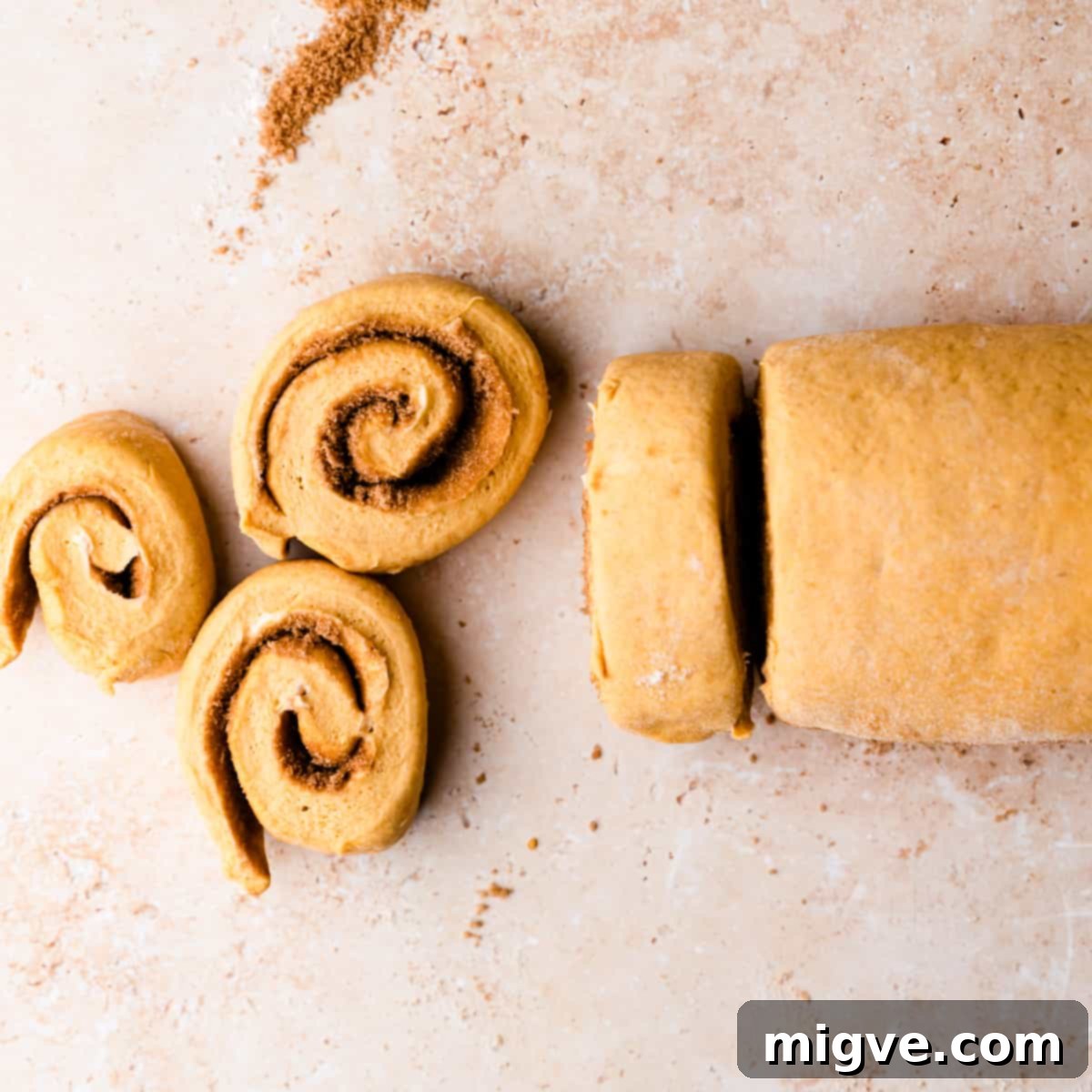 Rolled dough cut into even slices, ready for the baking dish.
