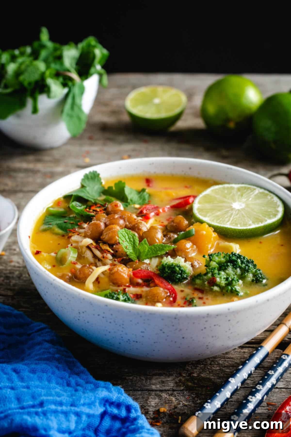 Single bowl of Thai style pumpkin laksa topped with crunchy chickpeas