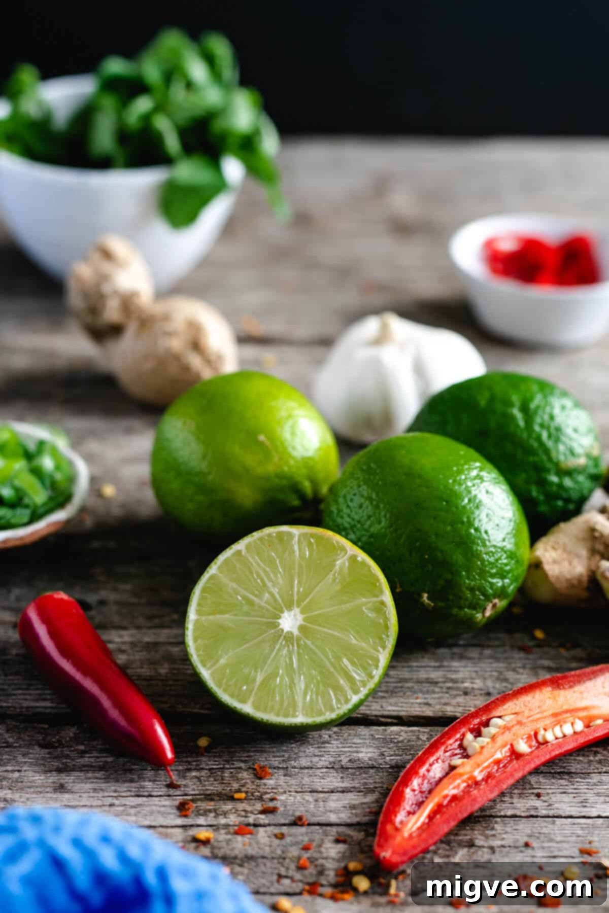 Loose limes and chillies on a wooden table