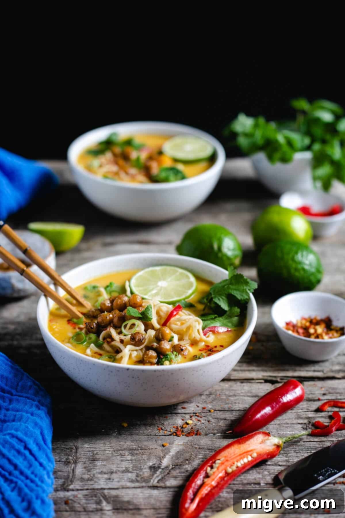 Straight ahead shot of bowl with Thai style pumpkin laksa with another bowl in the background