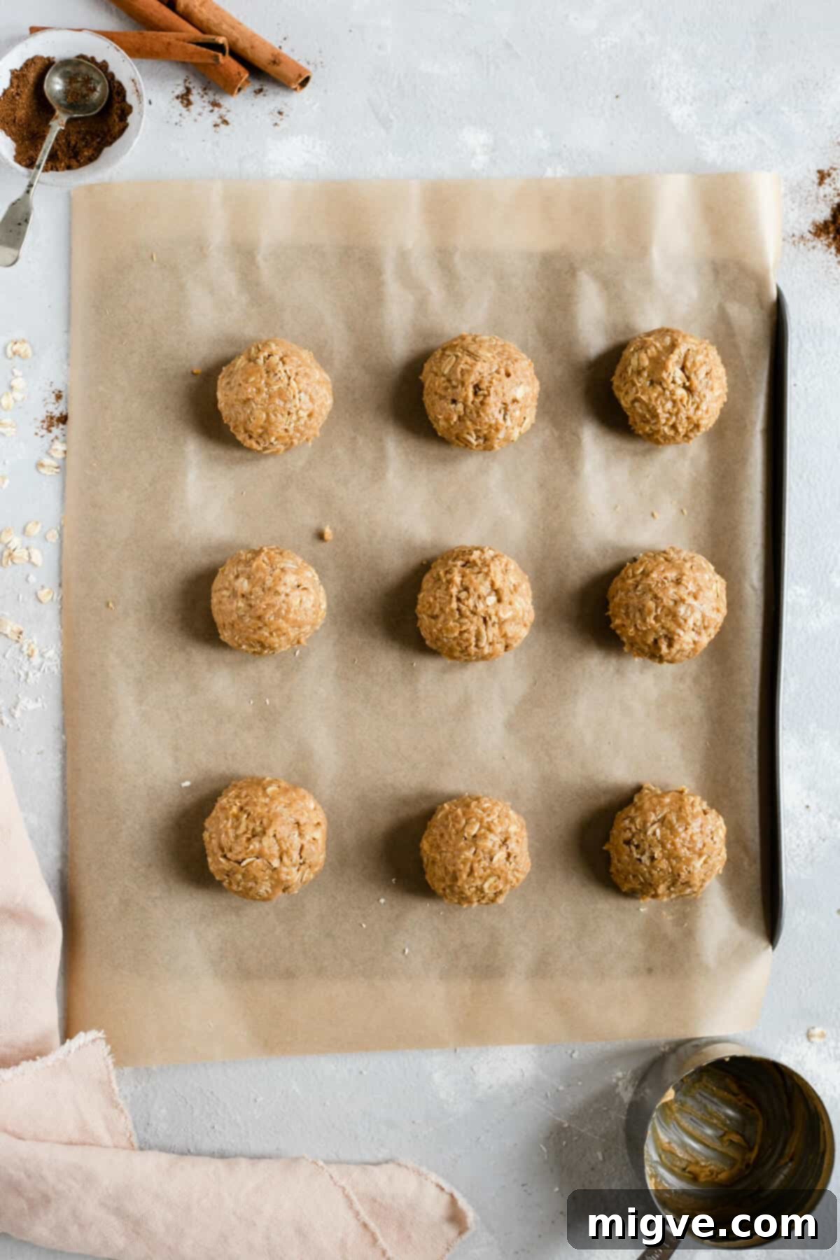 Spiced Coconut Peanut Power Bites 5 Overhead shot of perfectly formed coconut and peanut butter spiced energy bites arranged neatly on a baking tray, ready for chilling