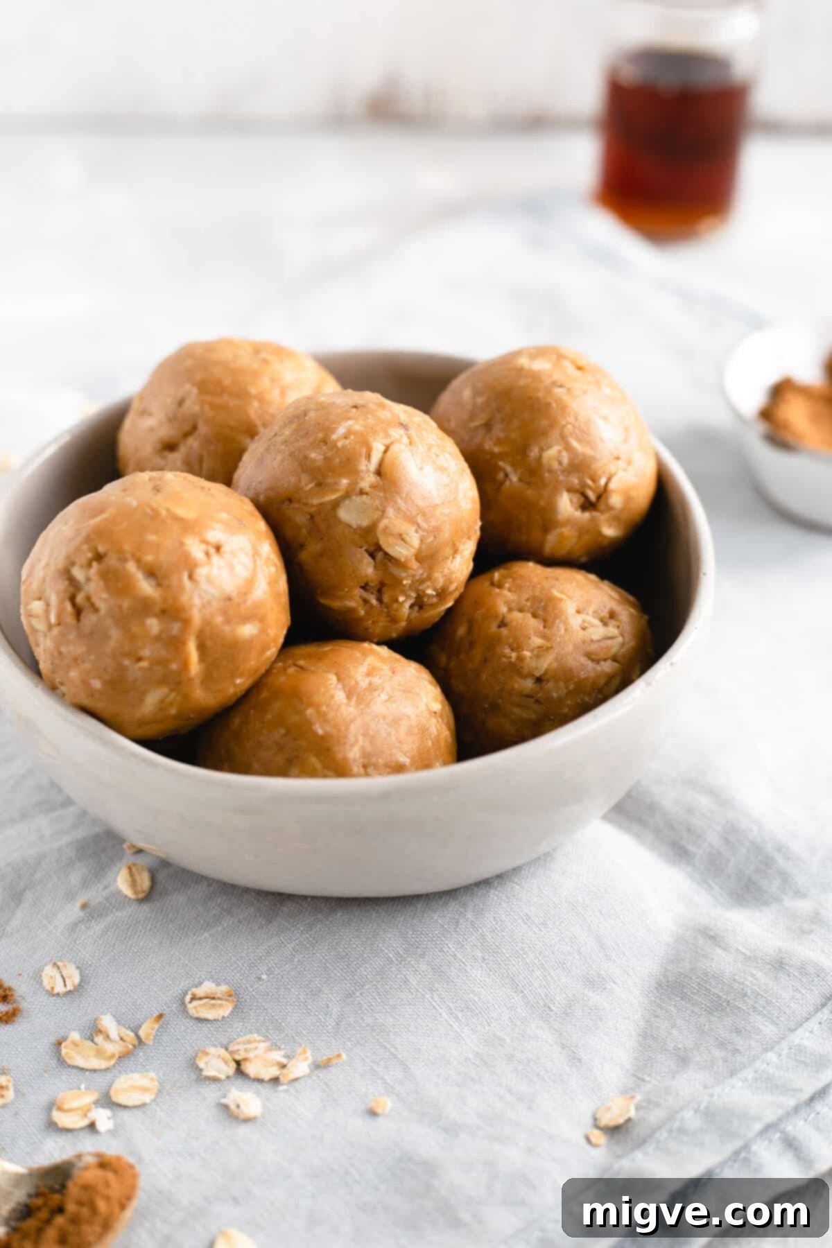 Spiced Coconut Peanut Power Bites 7 Side shot of a small bowl filled to the brim with tempting coconut and peanut butter spiced energy bites, ready to be enjoyed