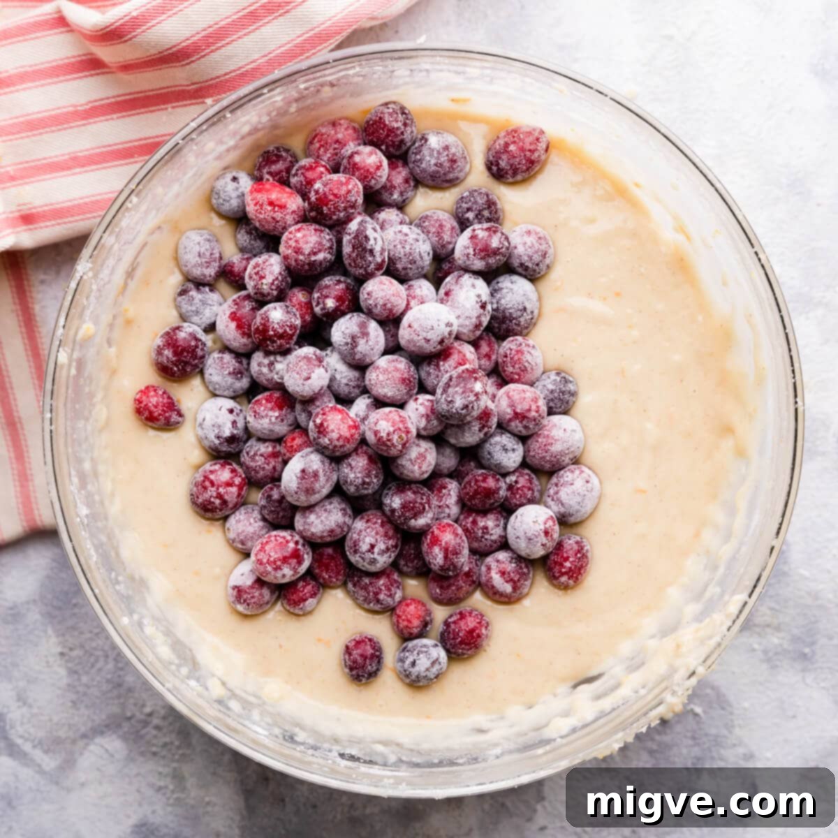 flour coated cranberries added to the bowl with cake batter.