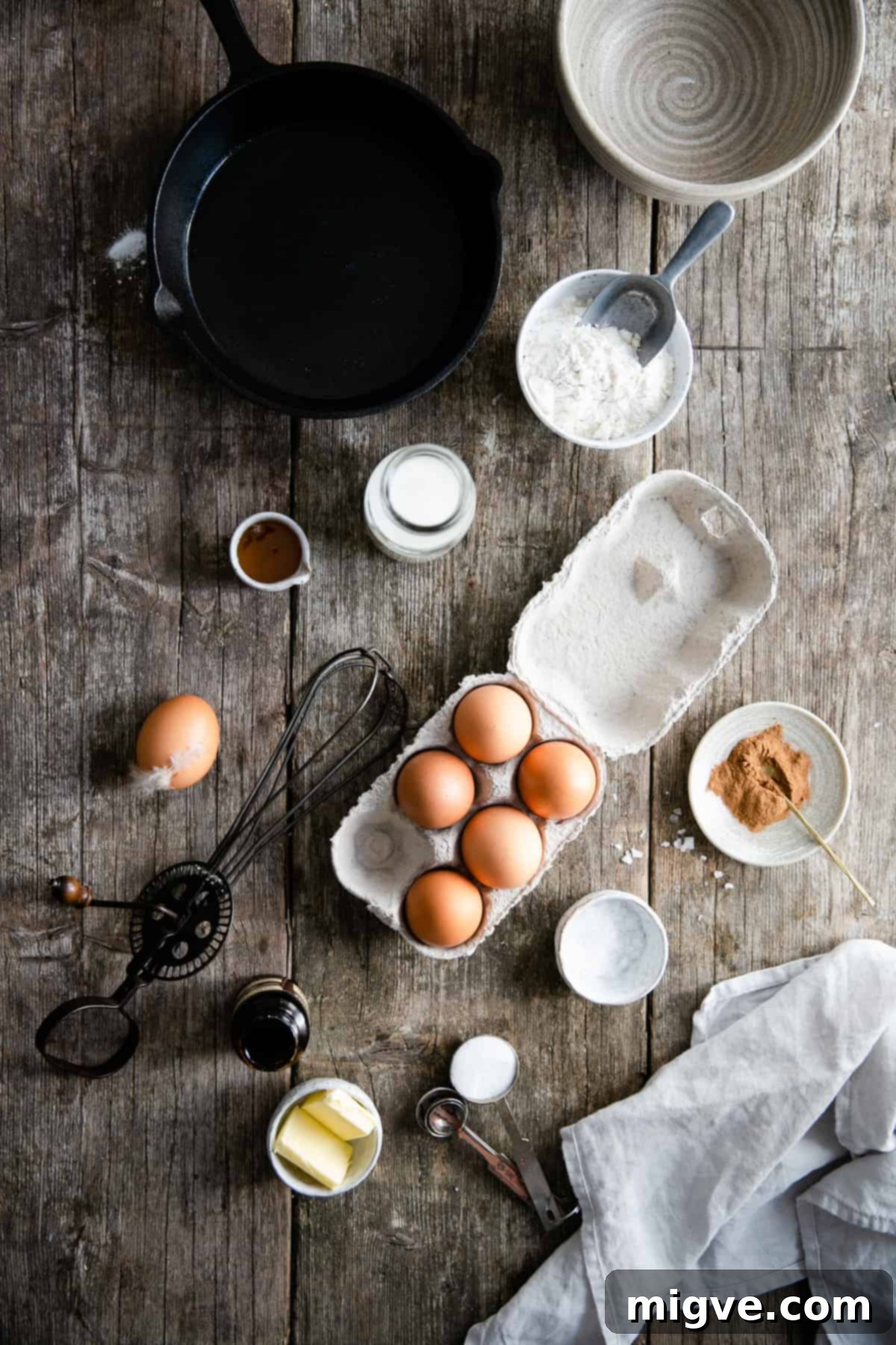 Berry Burst Dutch Delight 3 Overhead shot of ingredients on the table for mixed berry Dutch baby, including eggs, flour, butter, sugar, cinnamon, and milk