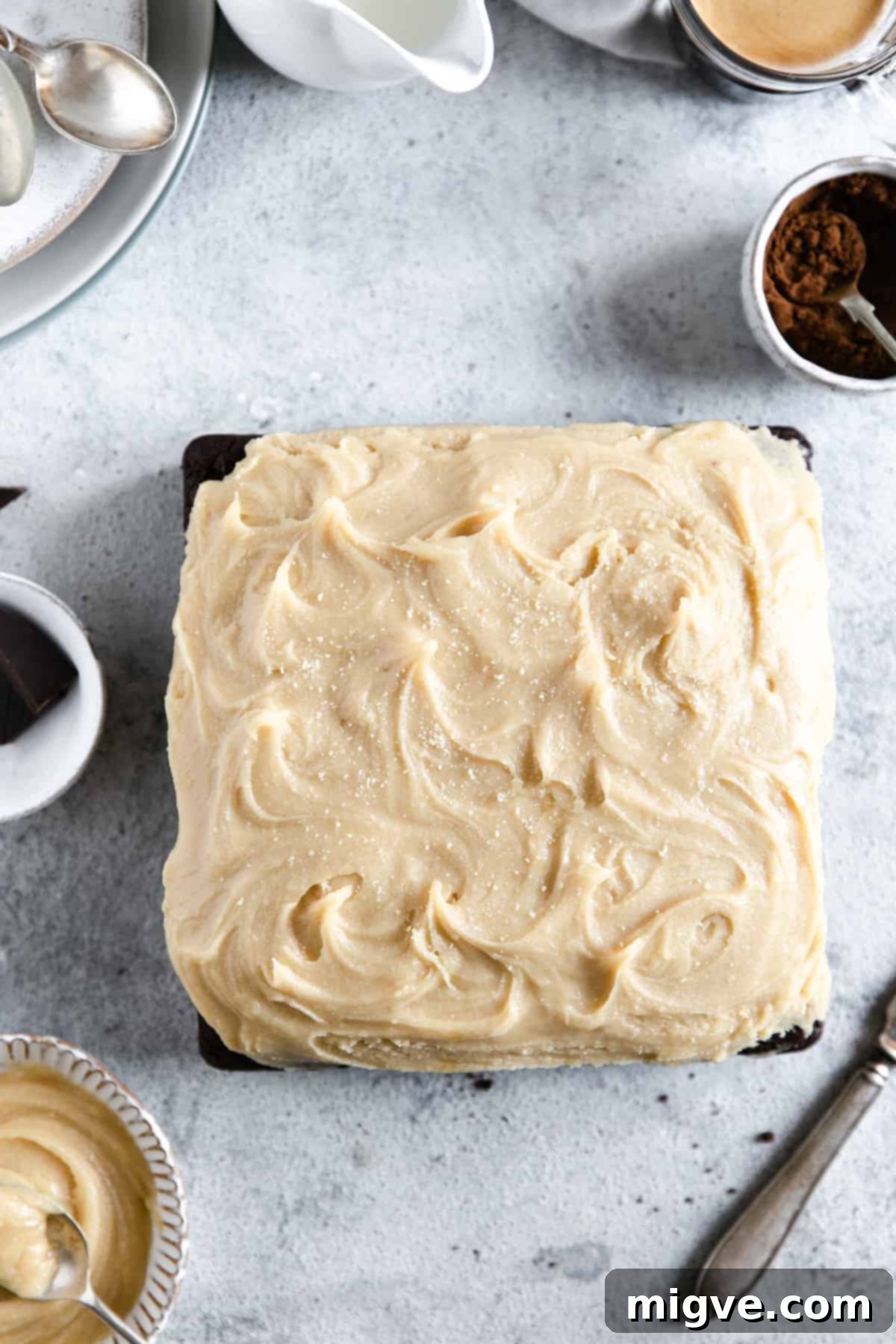 Overhead shot of unsliced chocolate brownie with peanut butter frosting