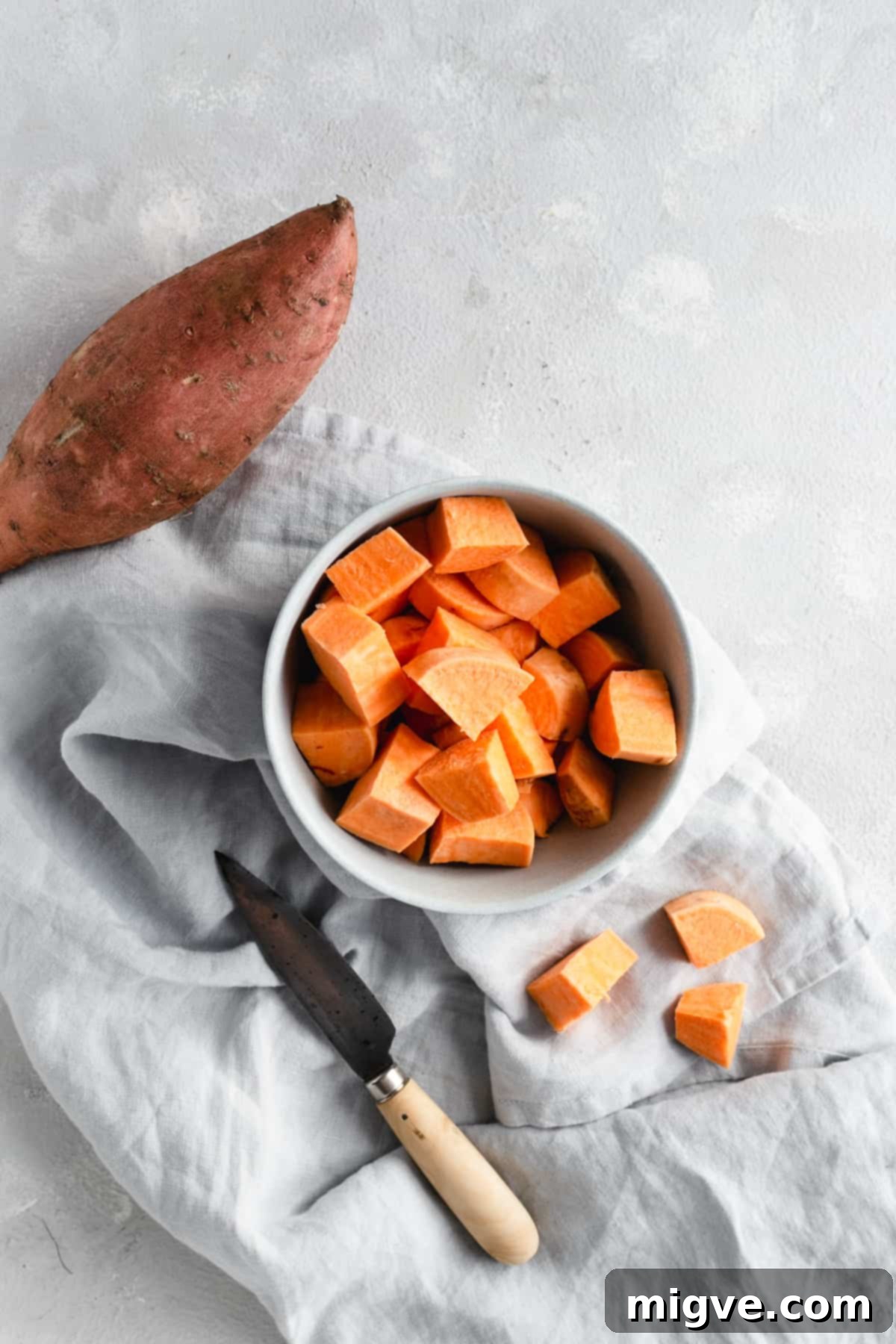 Golden Coconut Sweet Potato Curry 4 small bowl with chunks of sweet potato and a hand knife on side