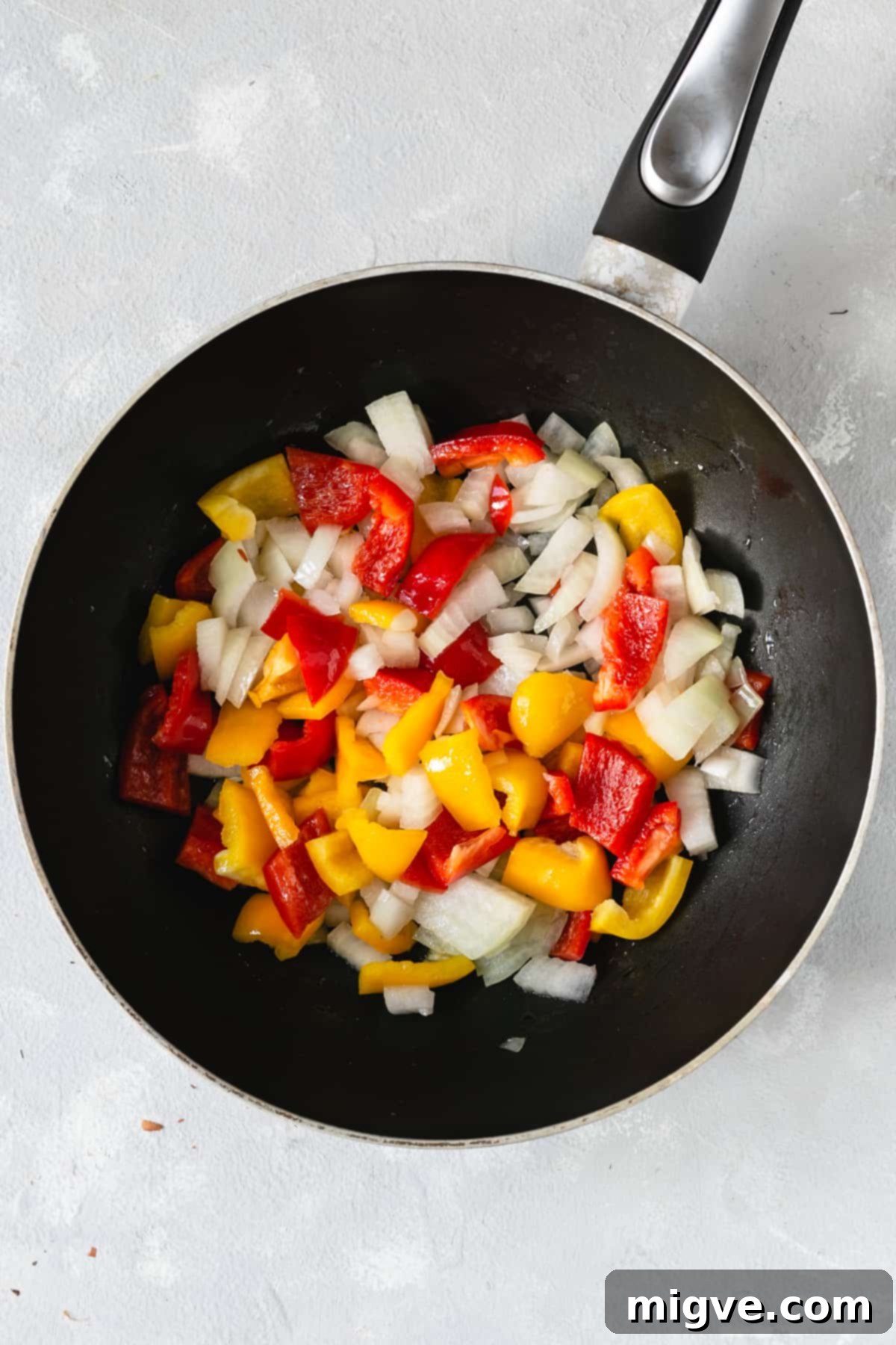 Golden Coconut Sweet Potato Curry 5 overhead shot of big frying pan with chopped onions and peppers