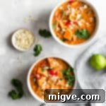 Golden Coconut Sweet Potato Curry 8 overhead shot of two small bowls with sweet potato curry with some toasted almonds and lime on side