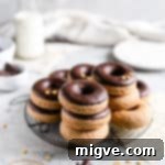 small stacks of baked doughnuts on a round cooling rack