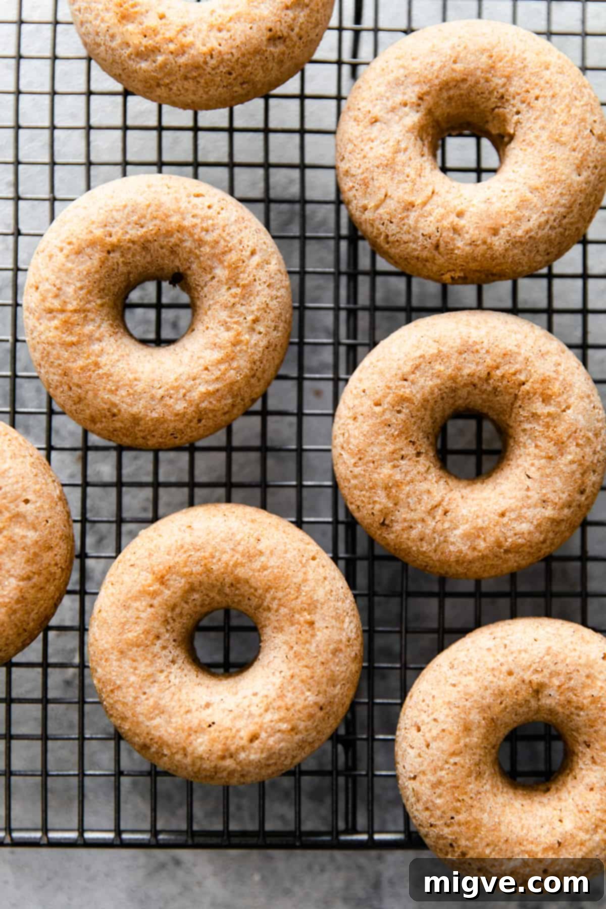 overhead shot of baked doughnuts on a cooling rack