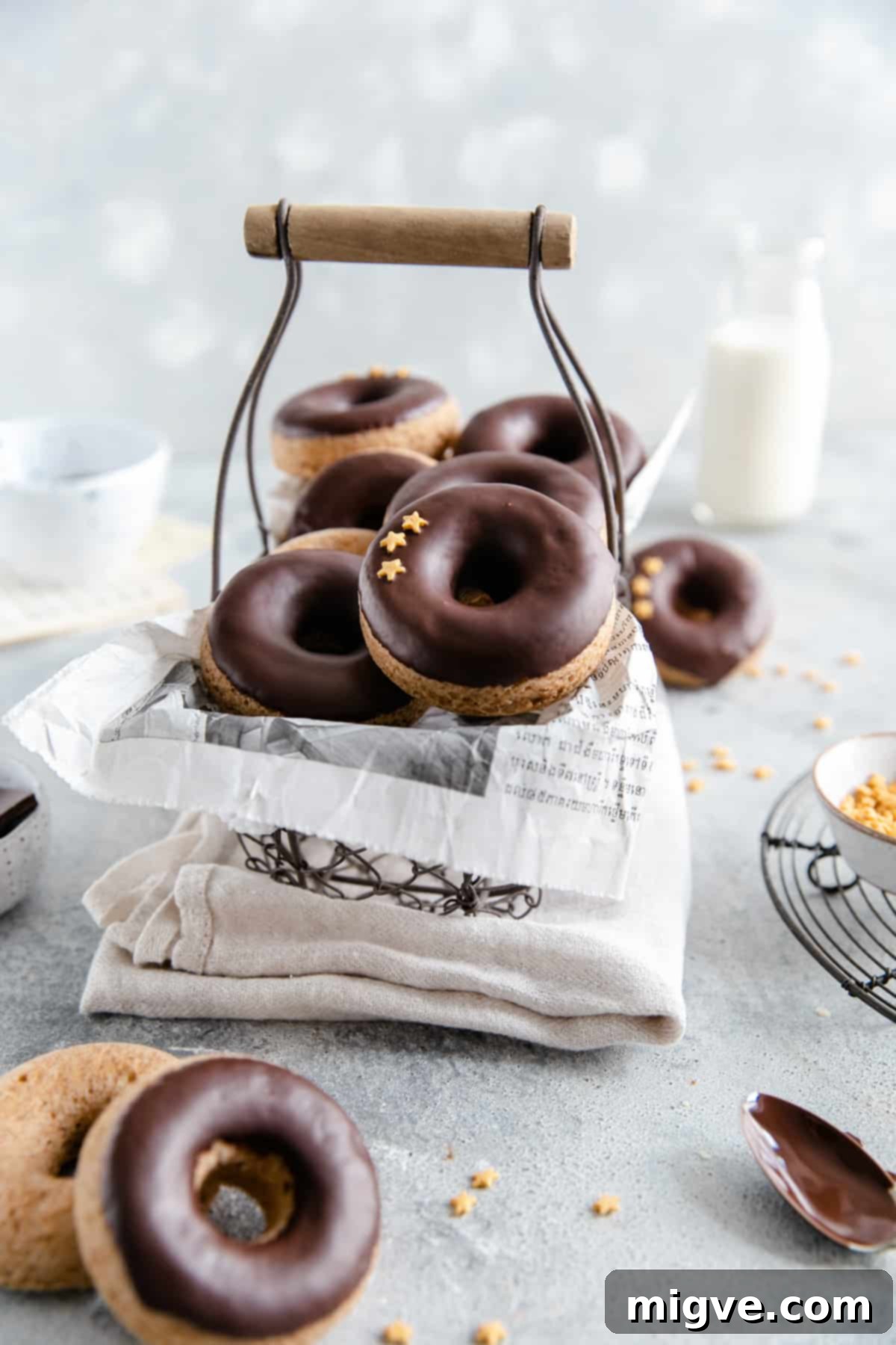 straight ahead shot of small wired basket filled with baked doughnuts with chocolate glaze