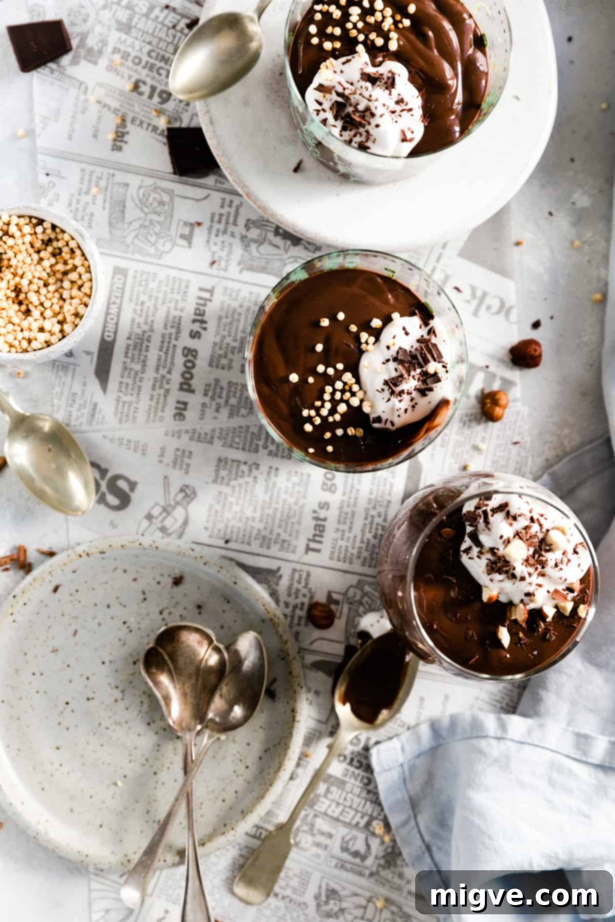 overhead shot of three glasses filled with vegan chocolate pudding