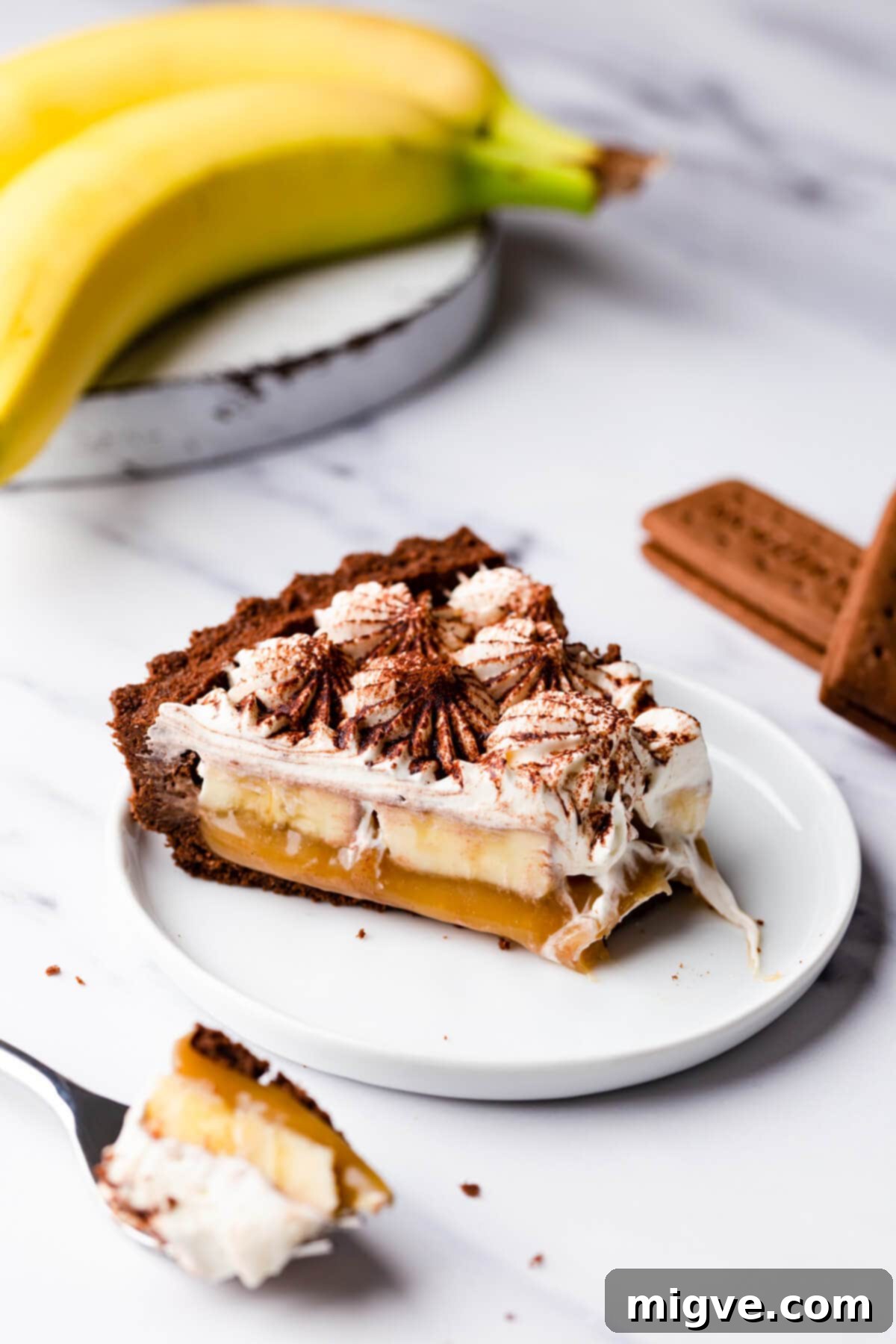 side close up showing a slice of vegan banoffee pie with a piece missing