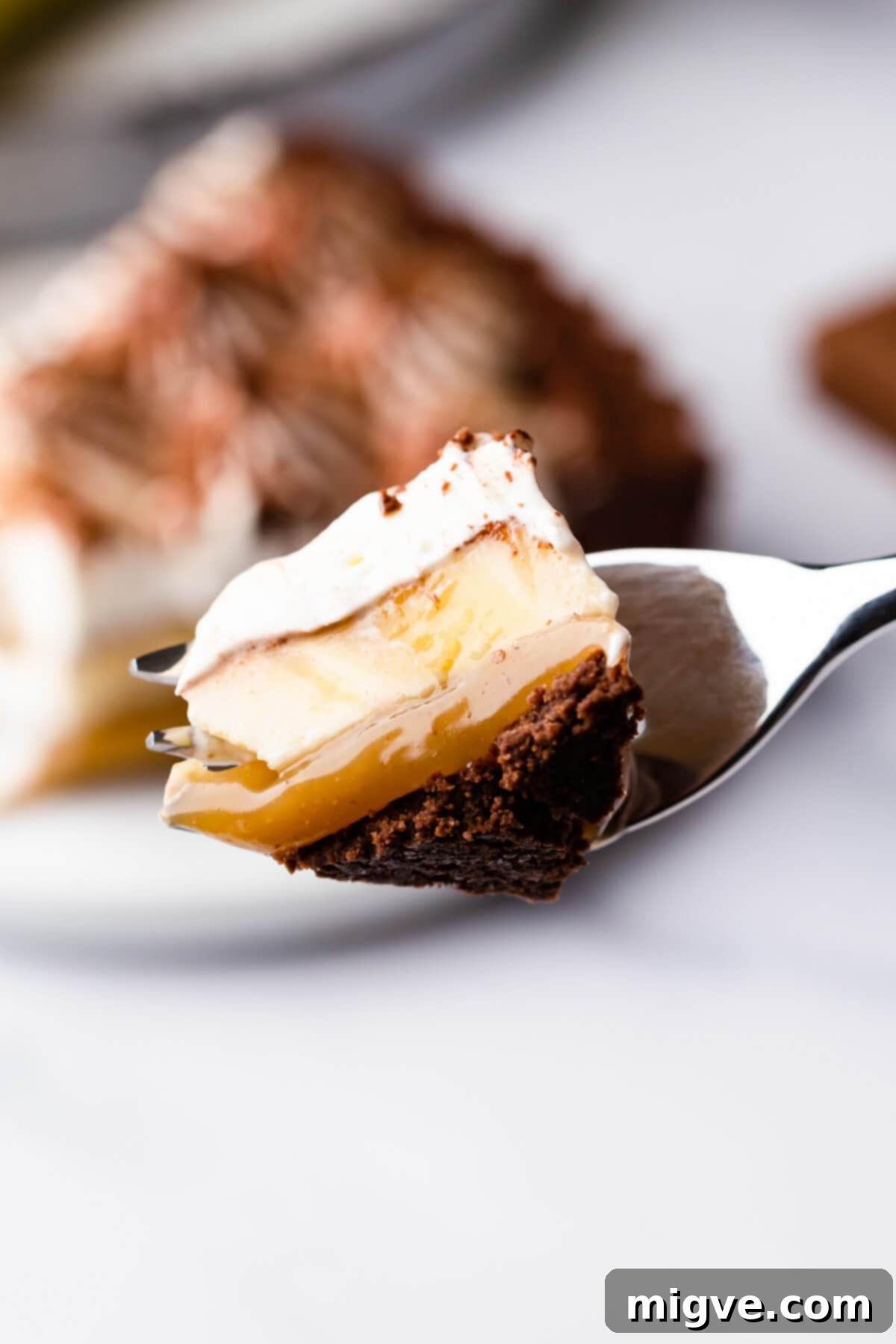 Overhead shot of a chocolate coconut banoffee pie with a slice being cut out