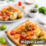 Vibrant Tomato & Savory Cheese Tartlets 12 side shot of single mixed tomato and cheese tartlet with some cooked new potatoes