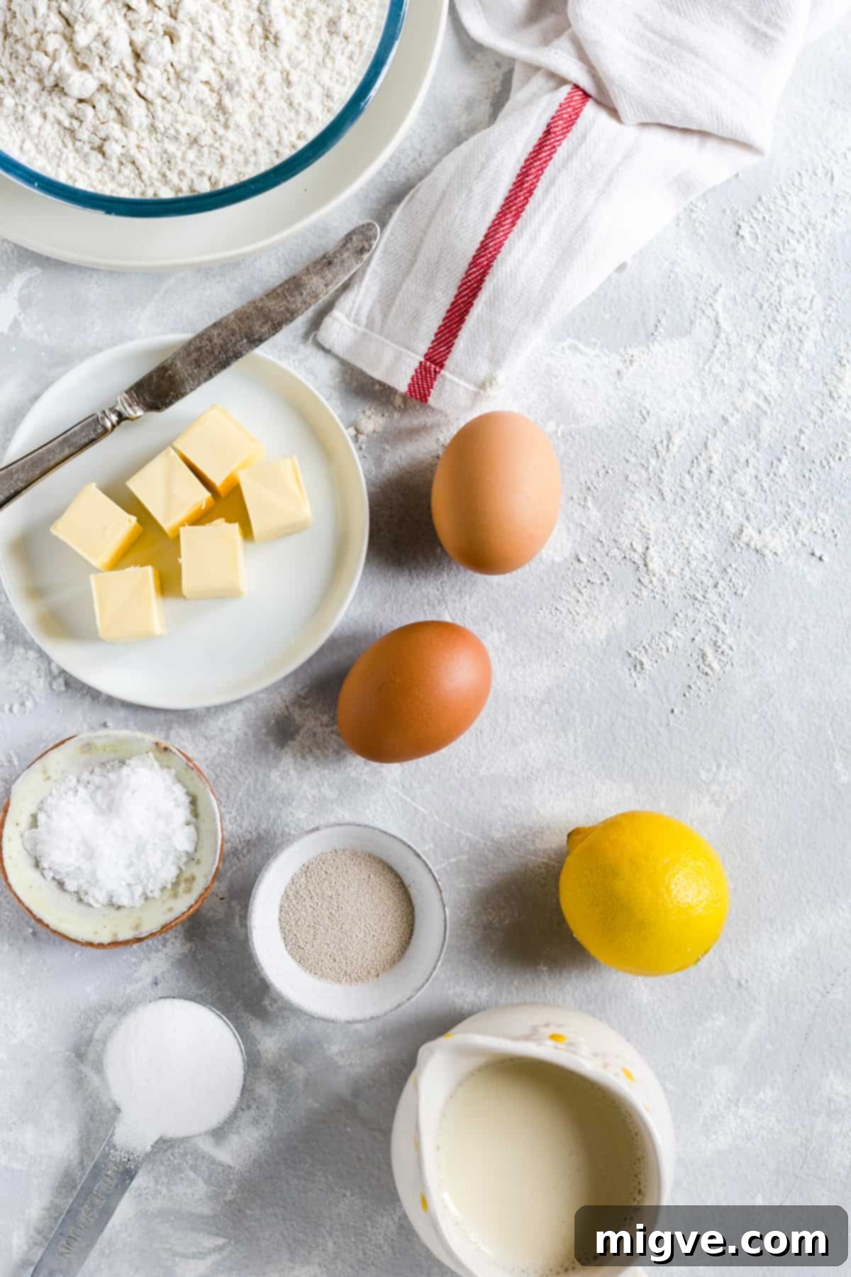 Swirled Chocolate Hazelnut Babka Buns 4 Overhead shot of the neatly arranged ingredients for chocolate hazelnut babka buns dough, including flour, sugar, yeast, and eggs.