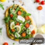Close-up of a rustic wooden board with a delicious slice of homemade asparagus green pesto pizza, highlighting the fresh ingredients and inviting texture.