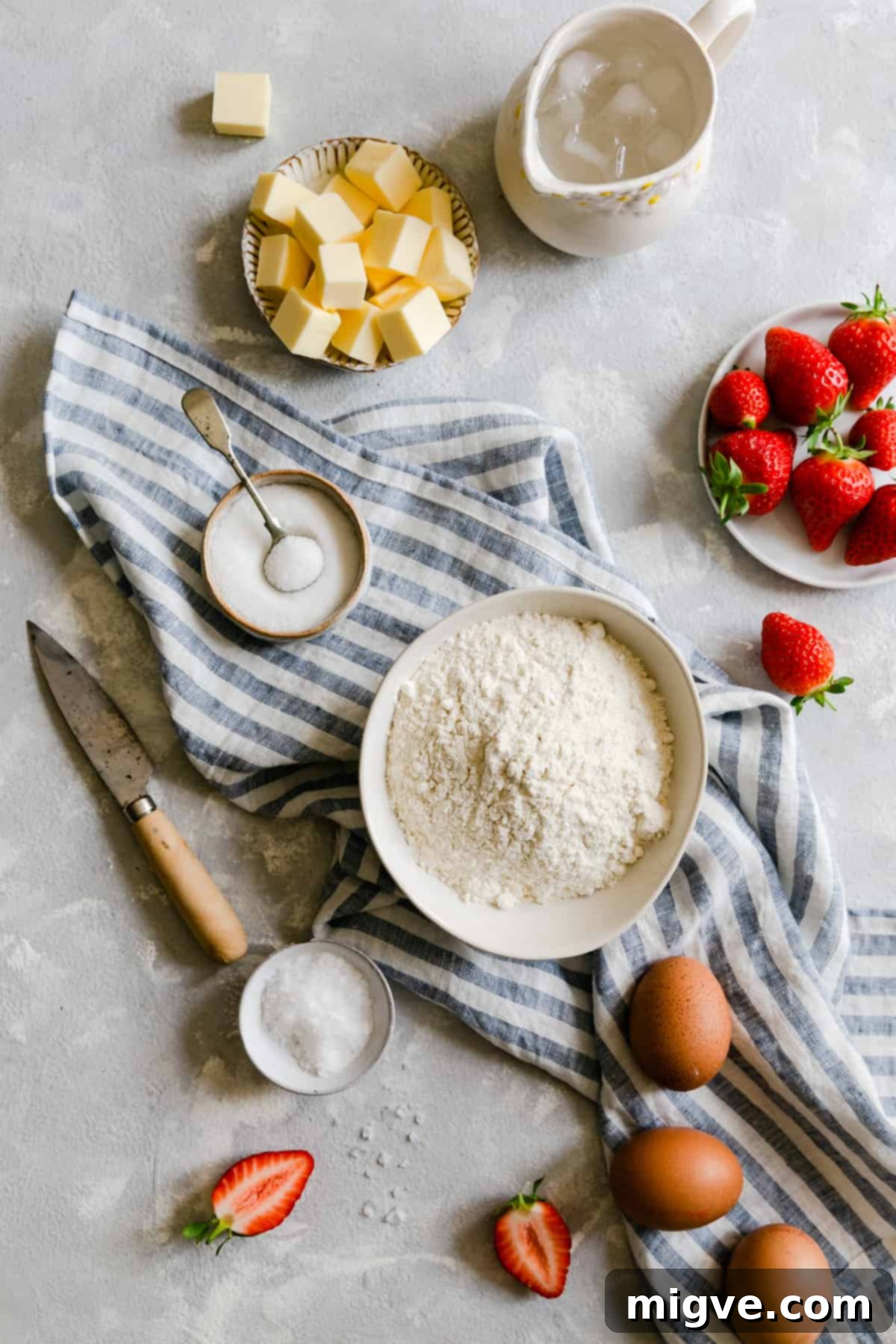 Rustic Strawberry Galette 5 top view of ingredients for strawberry galette, flour, butter, sugar, salt, water and fresh strawberries