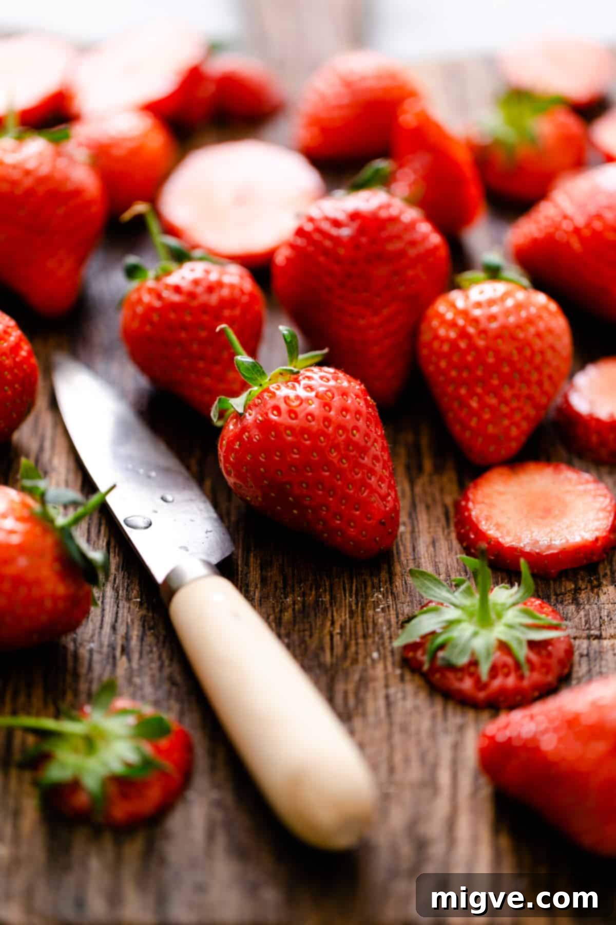 Rustic Strawberry Galette 8 a close up of fresh strawberries on a wooden chopping board