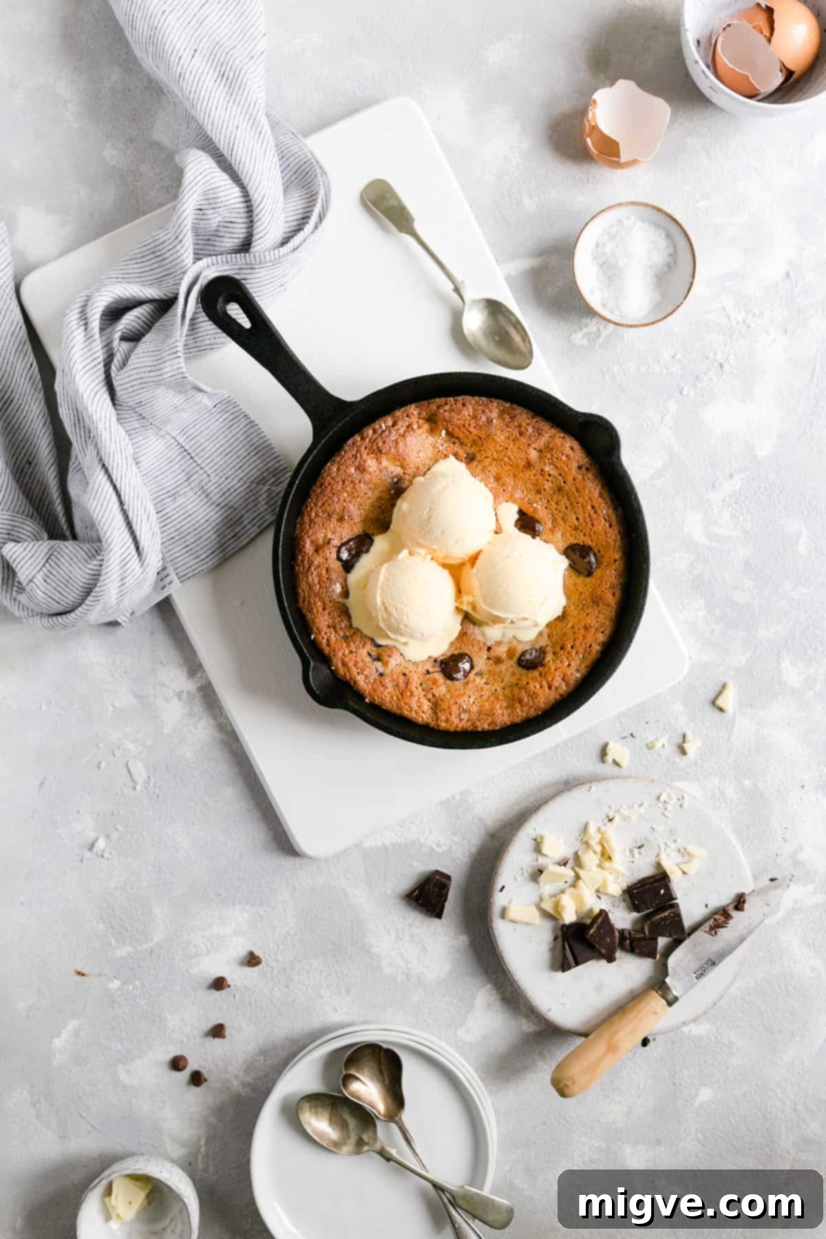 Top view of a freshly baked chocolate chip and malted milk skillet cookie, showcasing its golden edges and gooey interior.
