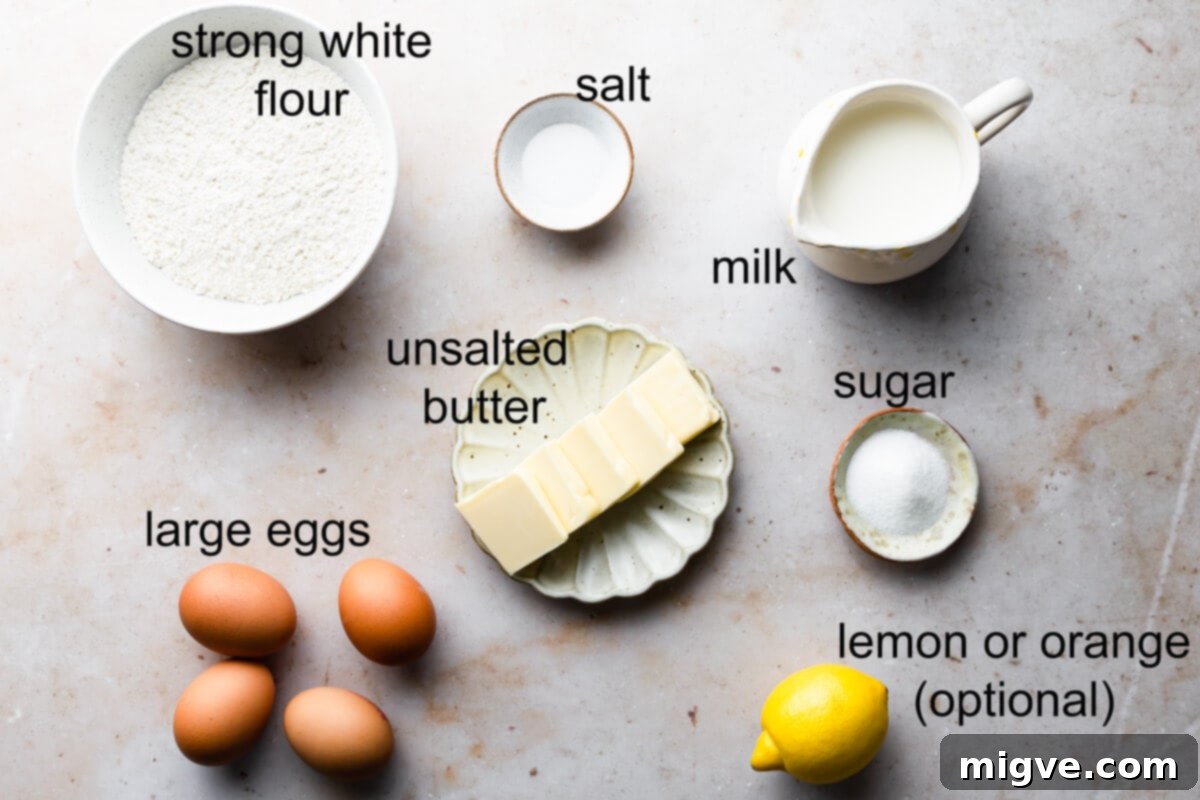 Airy Choux Rings 3 Overhead shot of all ingredients for French cruller doughnuts laid out on a kitchen counter, including milk, butter, sugar, salt, flour, eggs, lemon zest, vegetable oil, and powdered sugar.