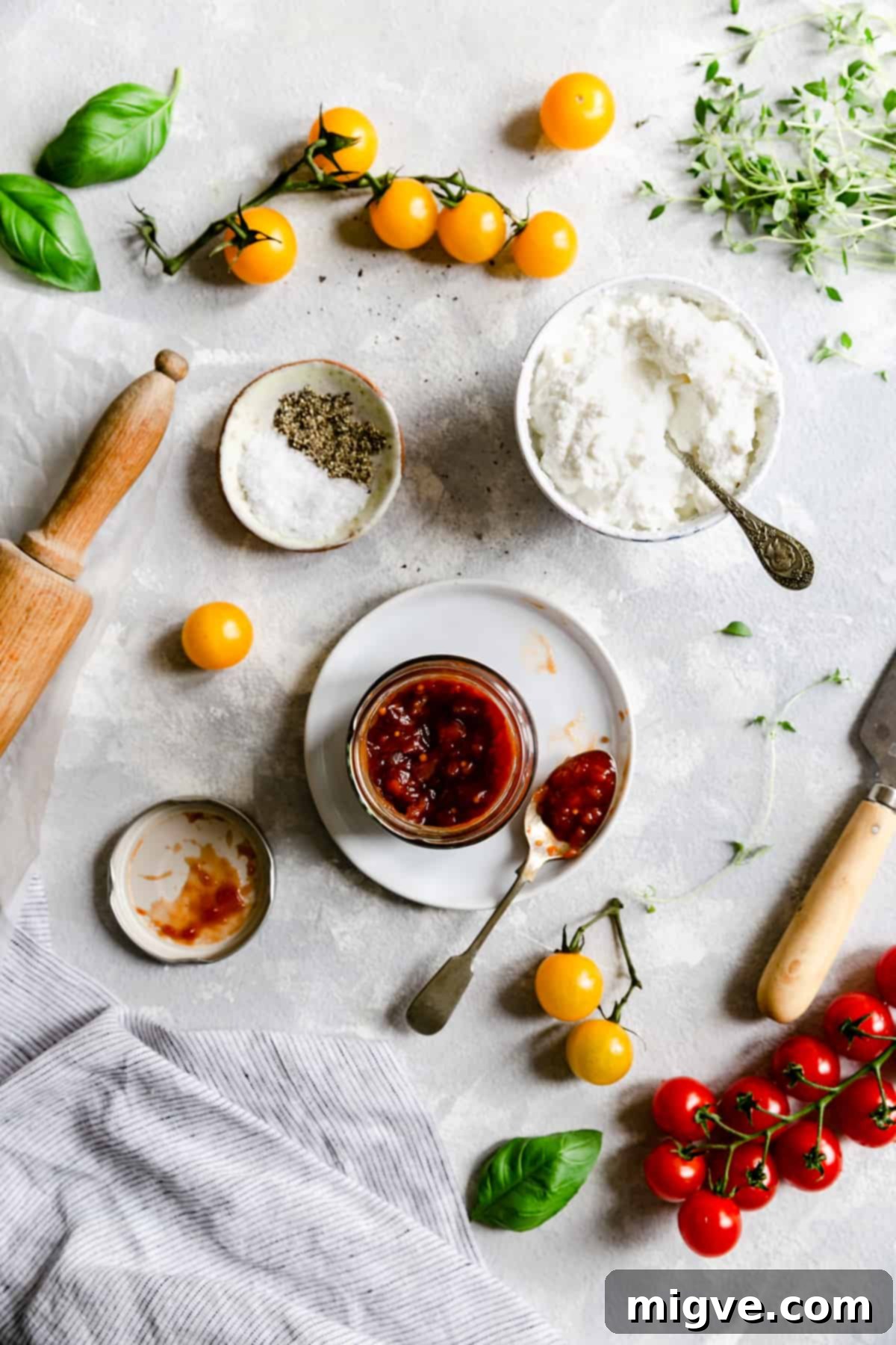 top view of essential tomato galette ingredients: creamy ricotta cheese, rich tomato jam, and fresh, colourful tomatoes
