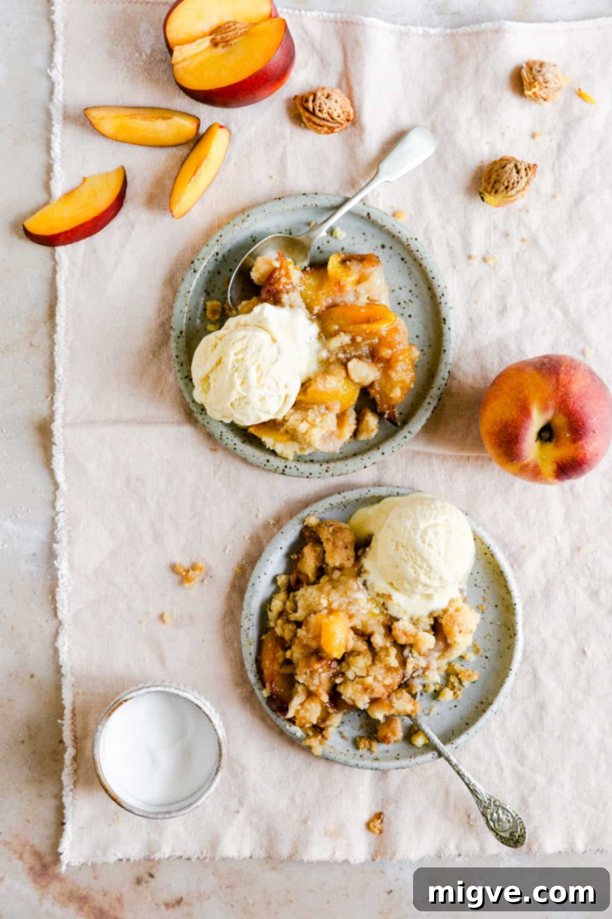top view of a delectable peach cobbler generously topped with vanilla ice cream