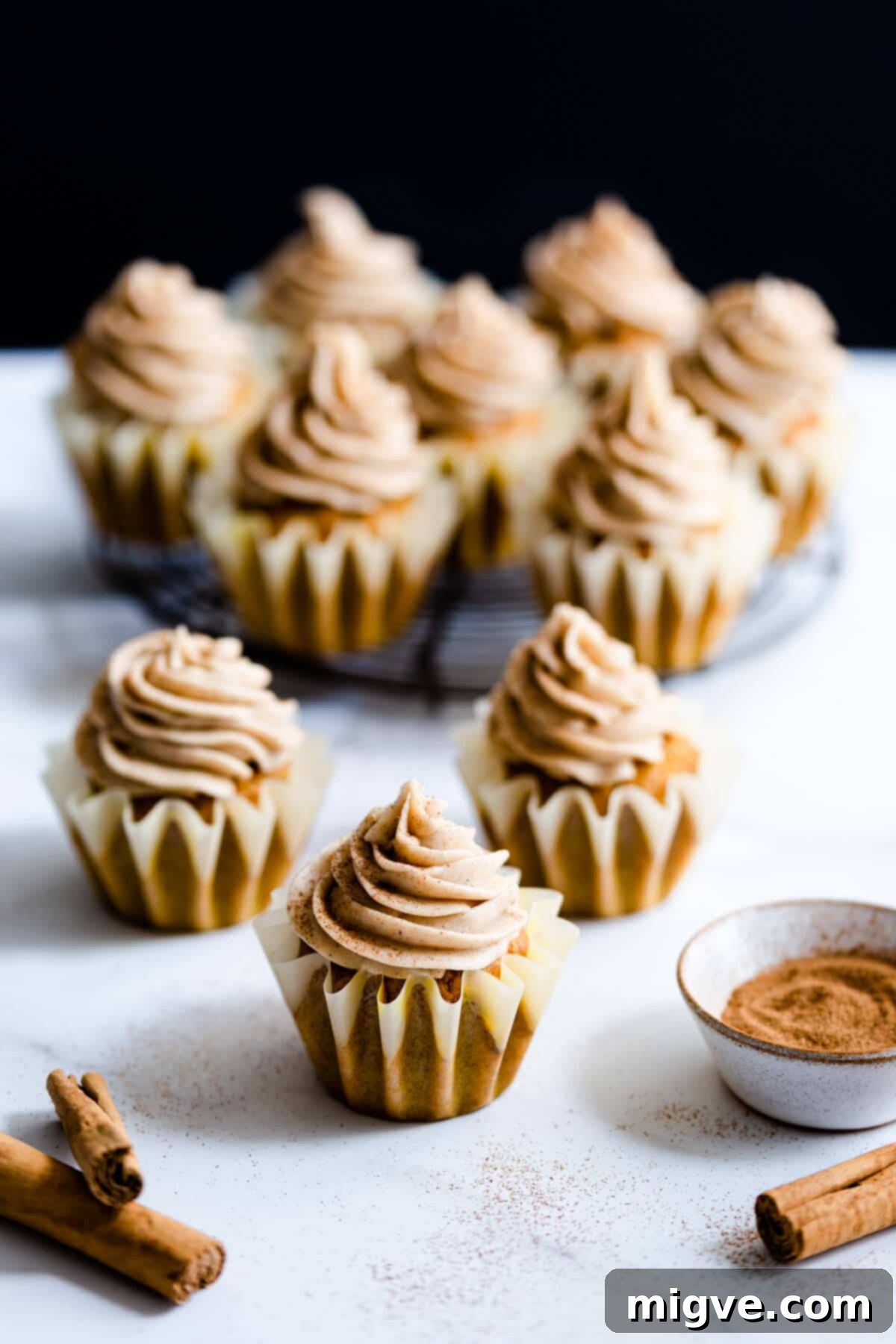 side shot of cupcakes topped with chai frosting, showcasing their beautiful appearance