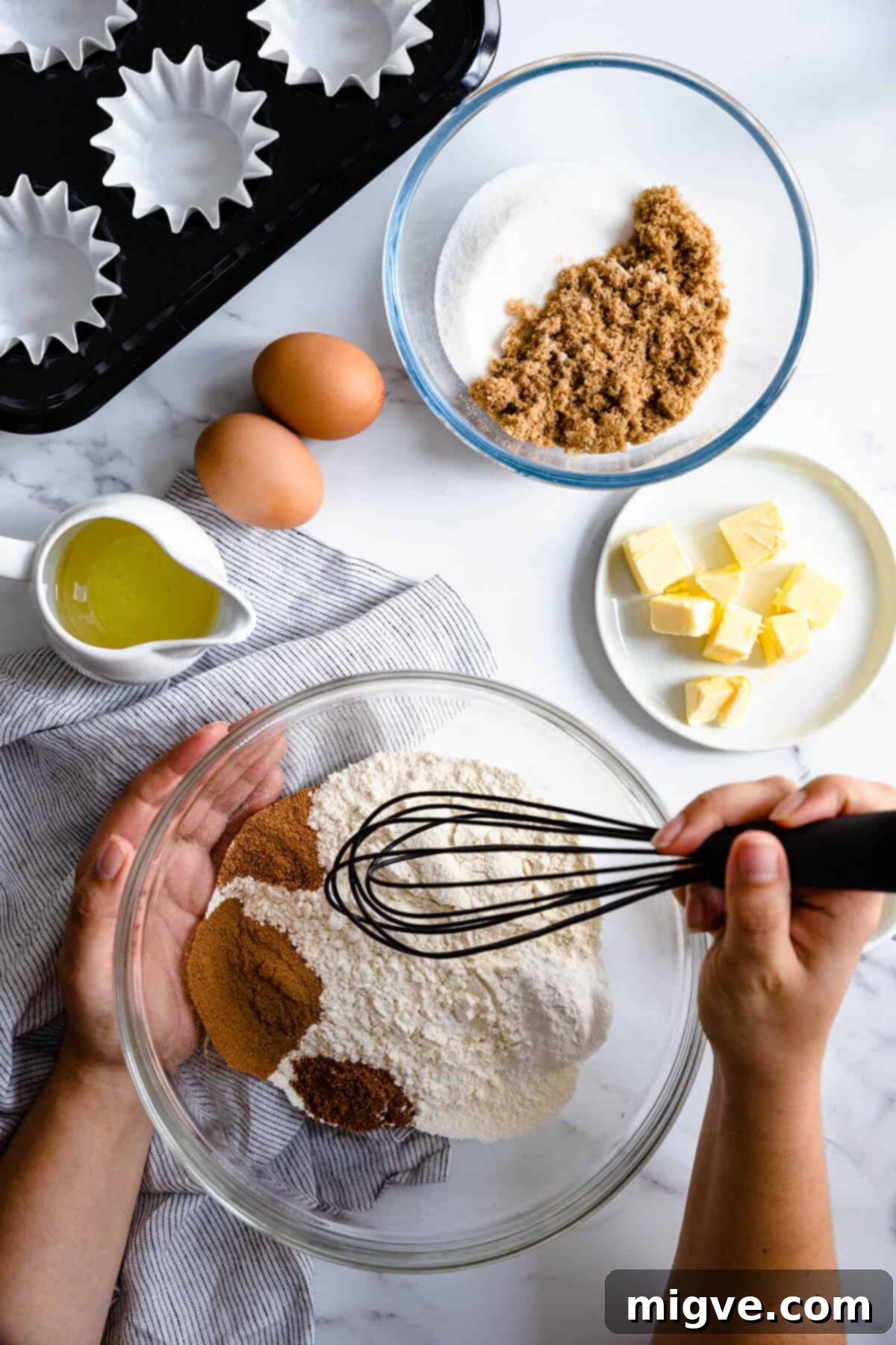 overhead shot of a person mixing some ingredients in a bowl with a standing mixer