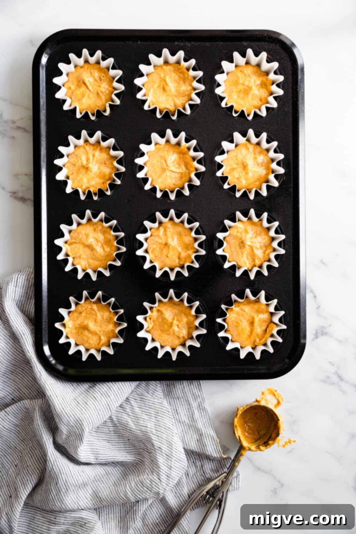 top view of baking tin filled with cupcake batter, ready for the oven