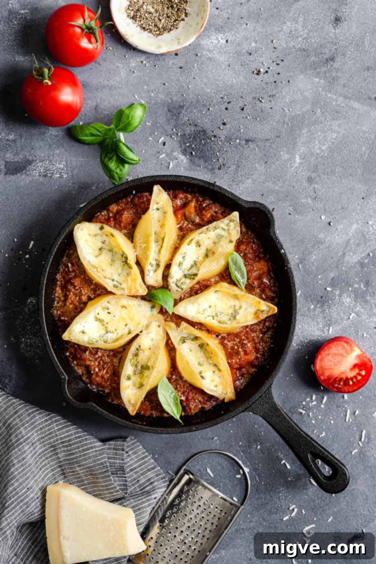 top view of a pan with stuffed pasta shells bake, golden and bubbling