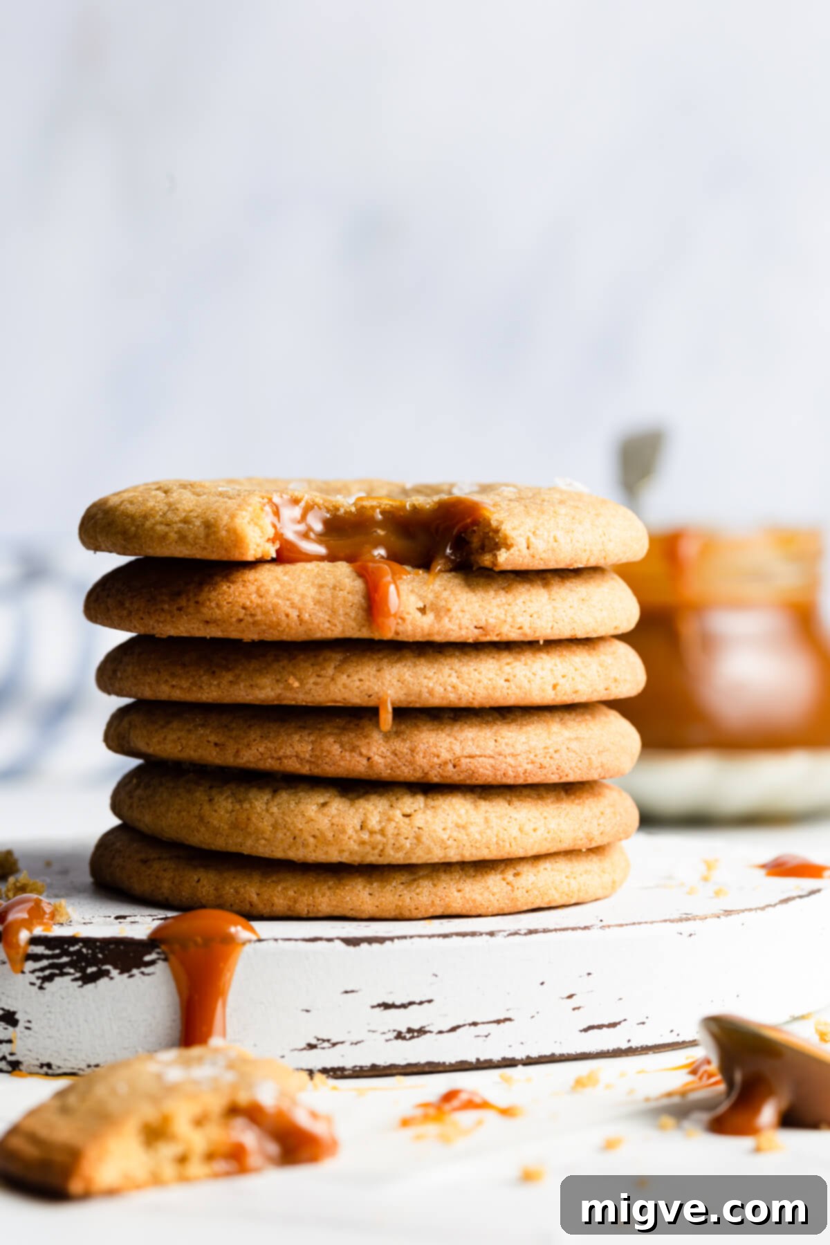 straight ahead super close up at a stack of six cookies with top one missing a bite