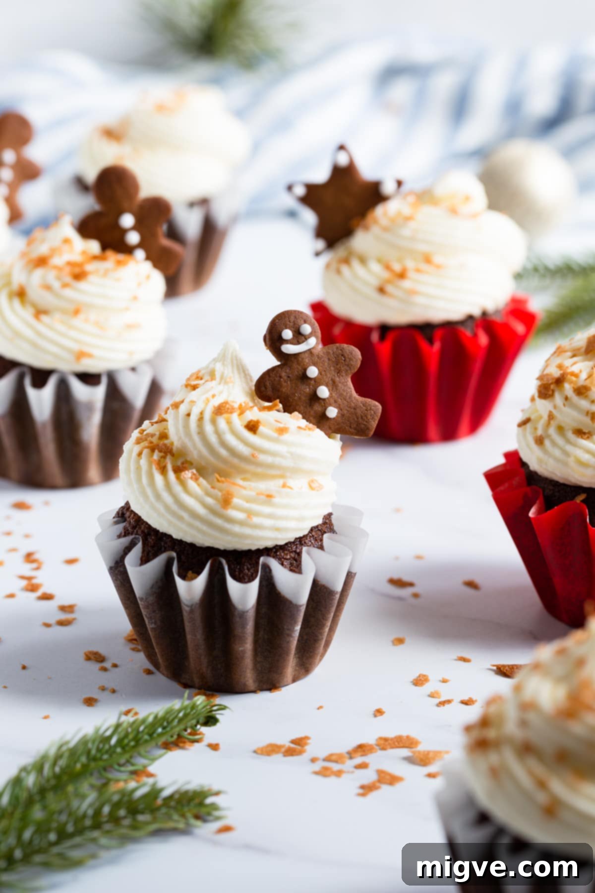 Holiday Gingerbread Delights with Cream Cheese Clouds 2 45 degree angle view at festive cupcake with frosting and small gingerbread cookie on top