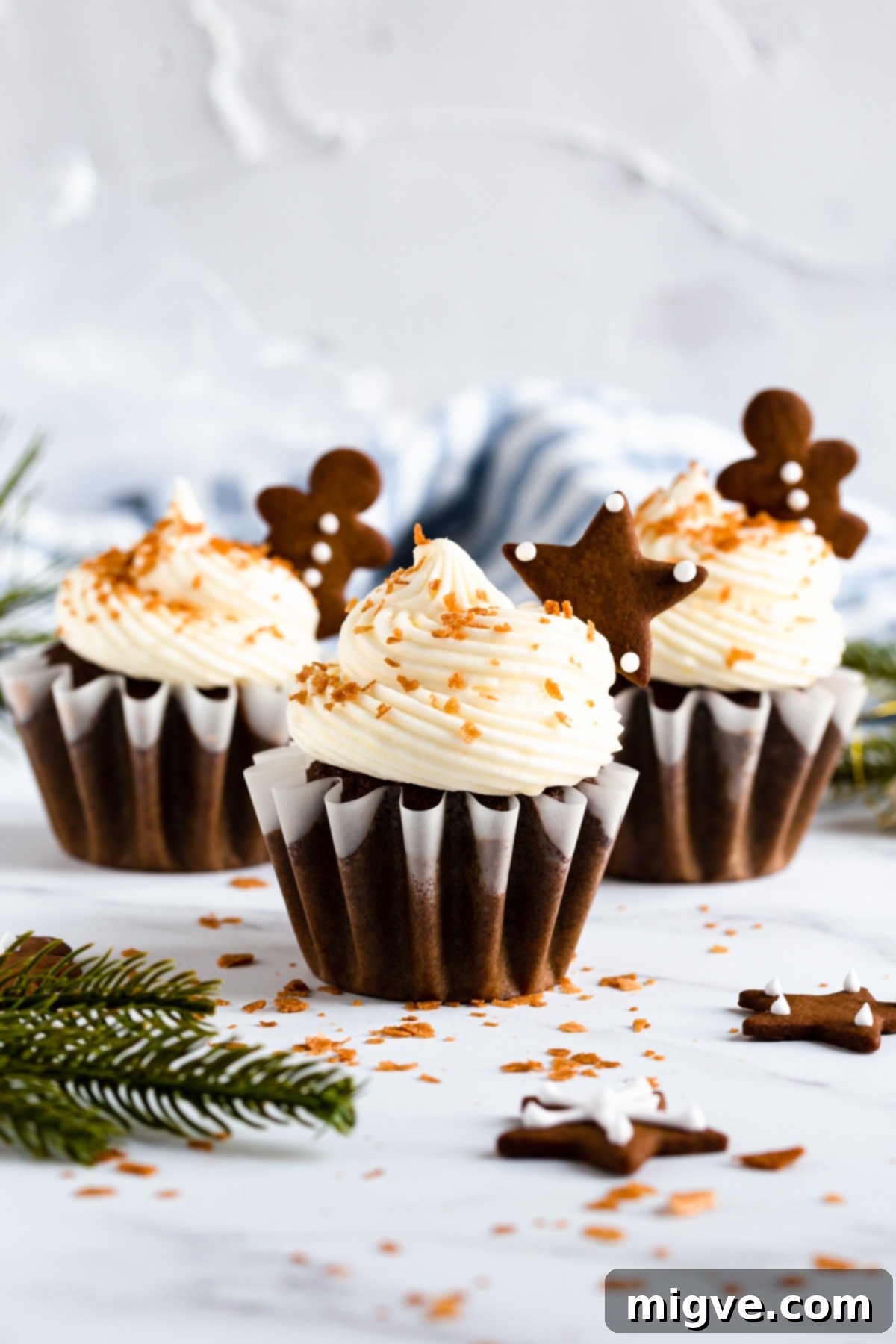 Holiday Gingerbread Delights with Cream Cheese Clouds 10 straight ahead view of the festive cupcakes topped with gingerbread
